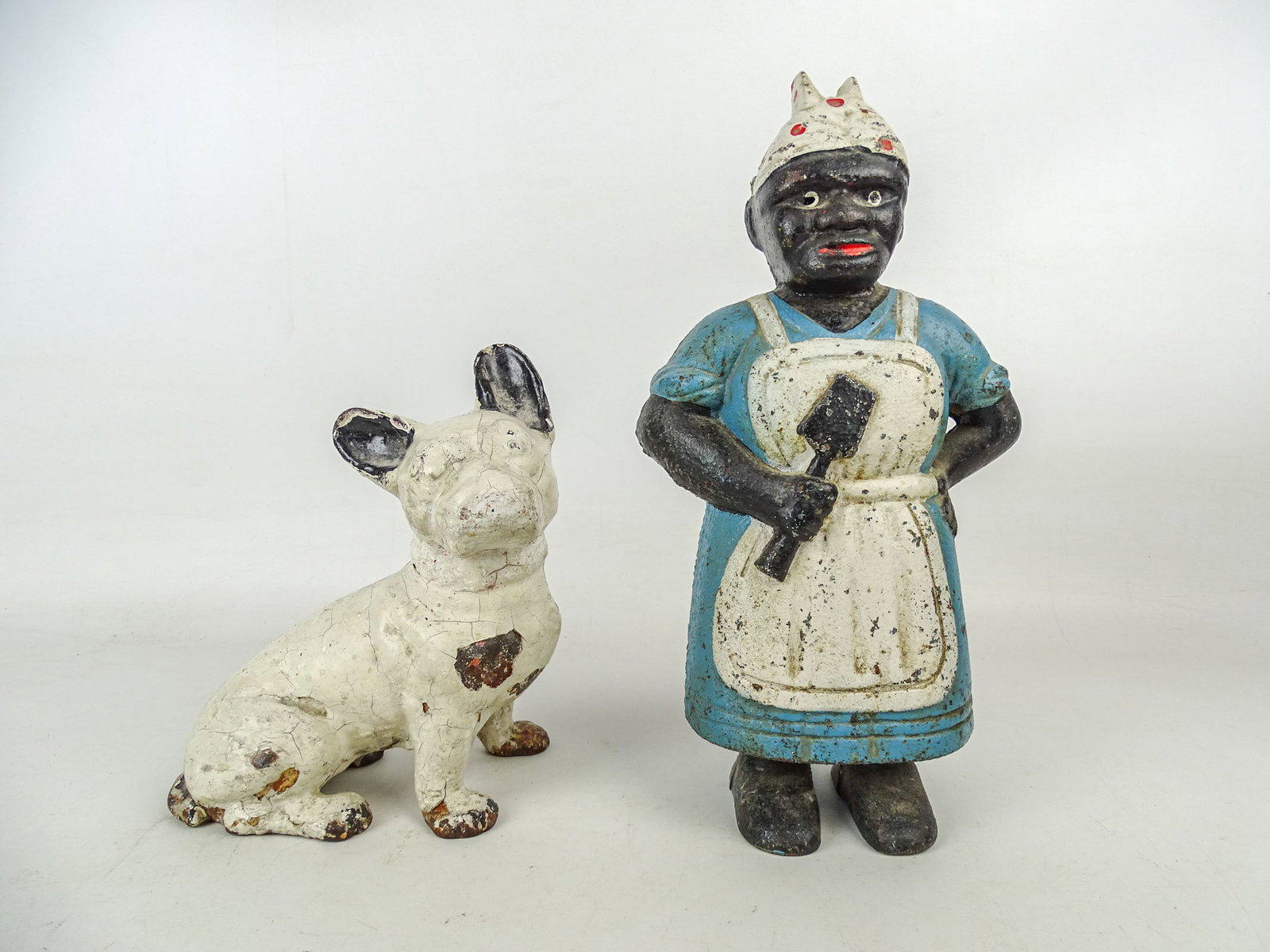 Doorstop Lot: Lot (2) cast iron doorstops including Mammy (12 1/2" Ht.), and Boston Terrier (repaint, 8 1/2" Ht.).
