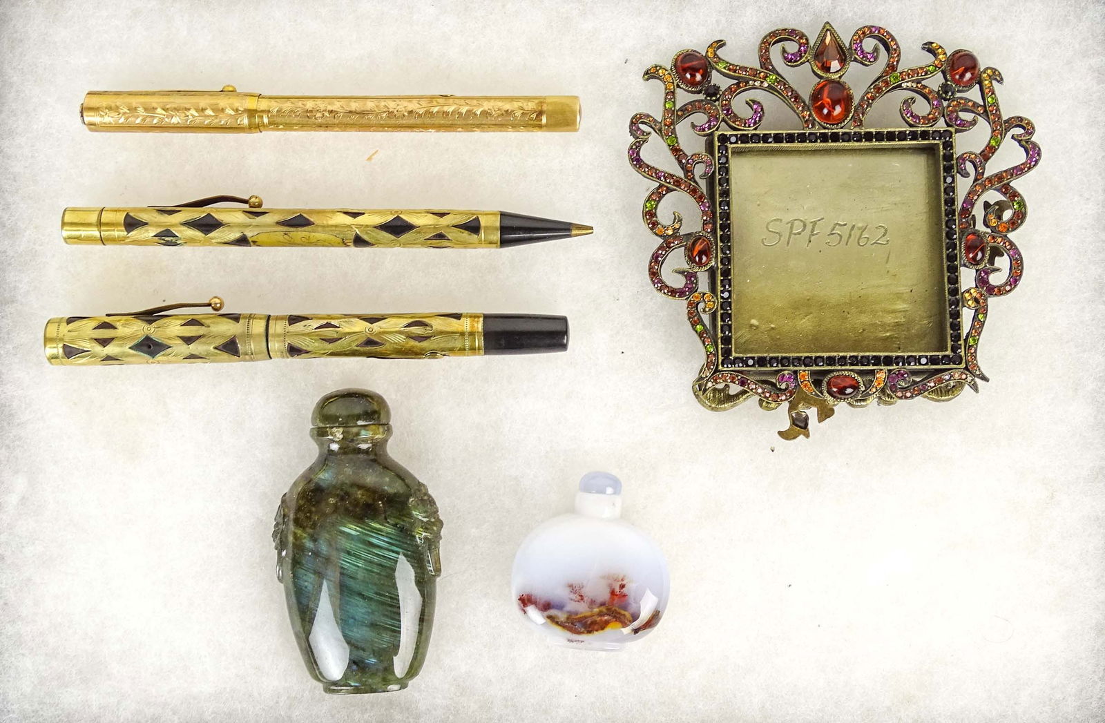 Misc. Lot: Misc. lot including (3) pens (one marked Waterman), Jay Strongwater frame (overall 4 1/2" x 4 1/2"), (2) stone Chinese snuff bottles.