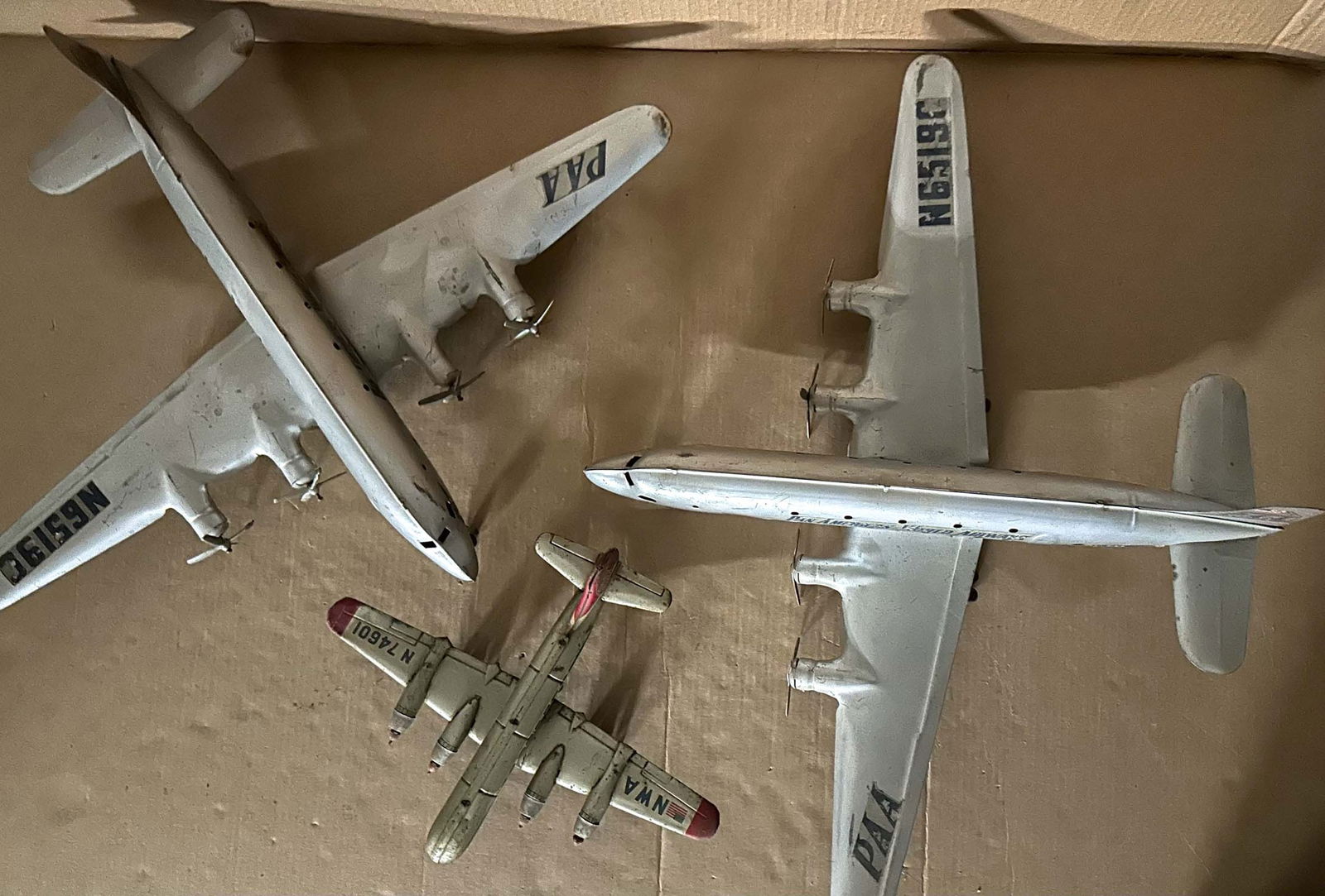 Tin Airplanes: Three tin toy airplanes, ca 1950's, two Marx DC 4's with props intact, 28 inch wingspan, 21 fuselage and smaller 14 inch, missing props, original paint and decals. Meltz Collection, Columbia County