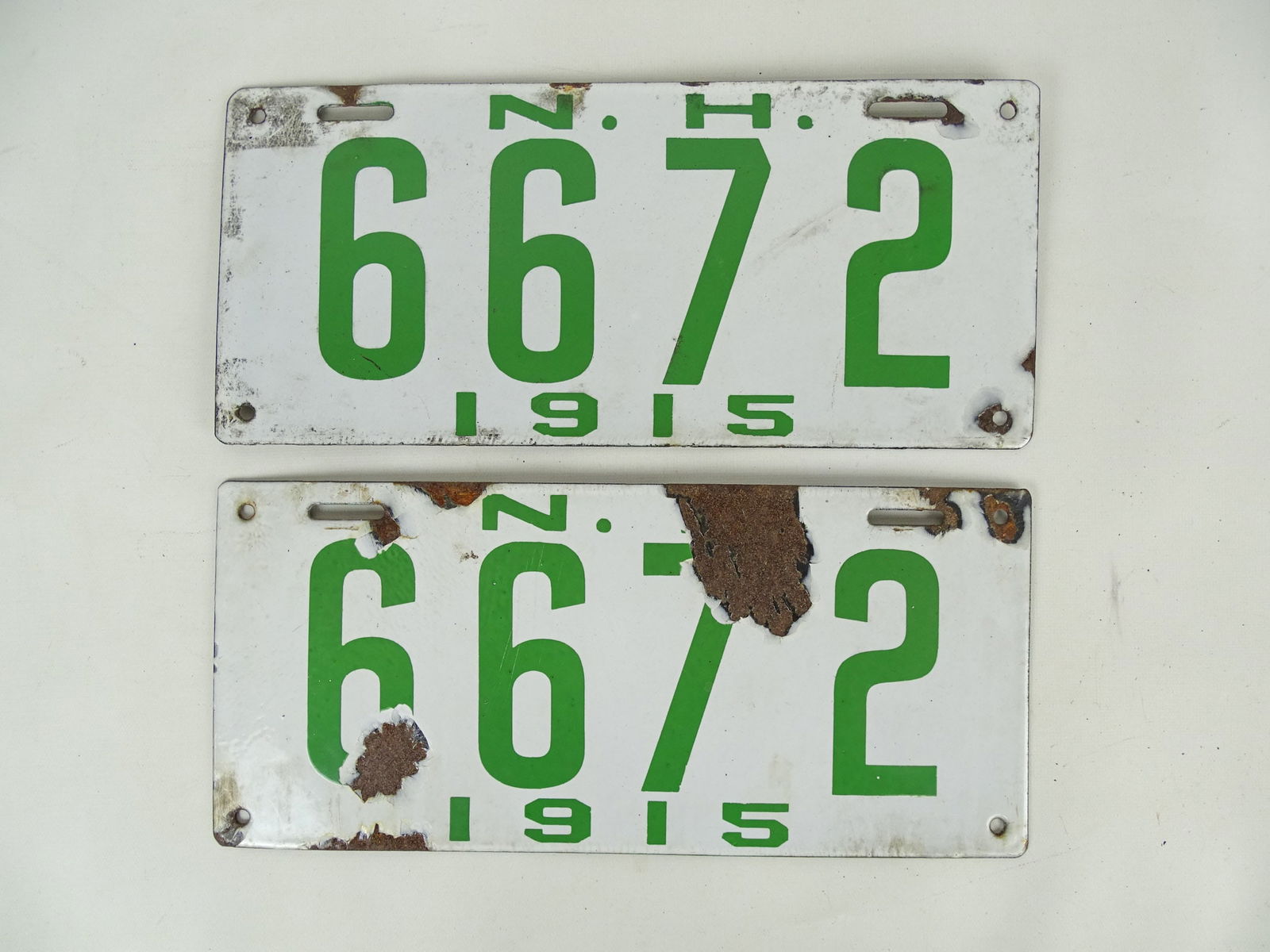 Auto License Plates, 1915: Pair of 1915 porcelain auto license plates, "NH 6672". 6" x 13 1/4".