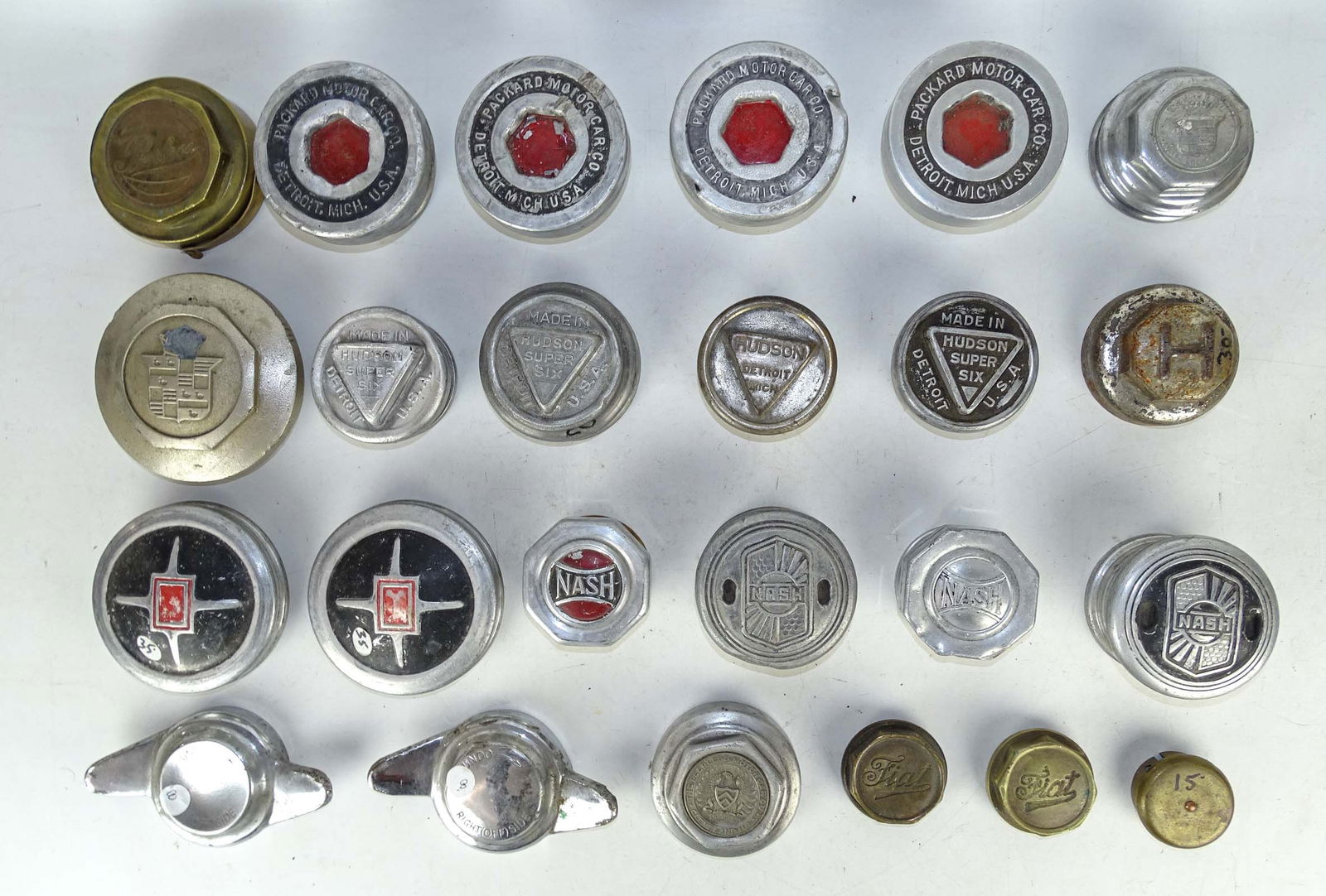 Misc. Vintage Auto Caps: Misc. vintage hub and grease caps, examples include: (4) Nash, (5) Hudson, (4) Packard, (2) Peerless, (2) Cadillac, (2) Winged "Knock-Offs", (2) Buick, and (2) Fiat cast brass. 23 examples. Meltz