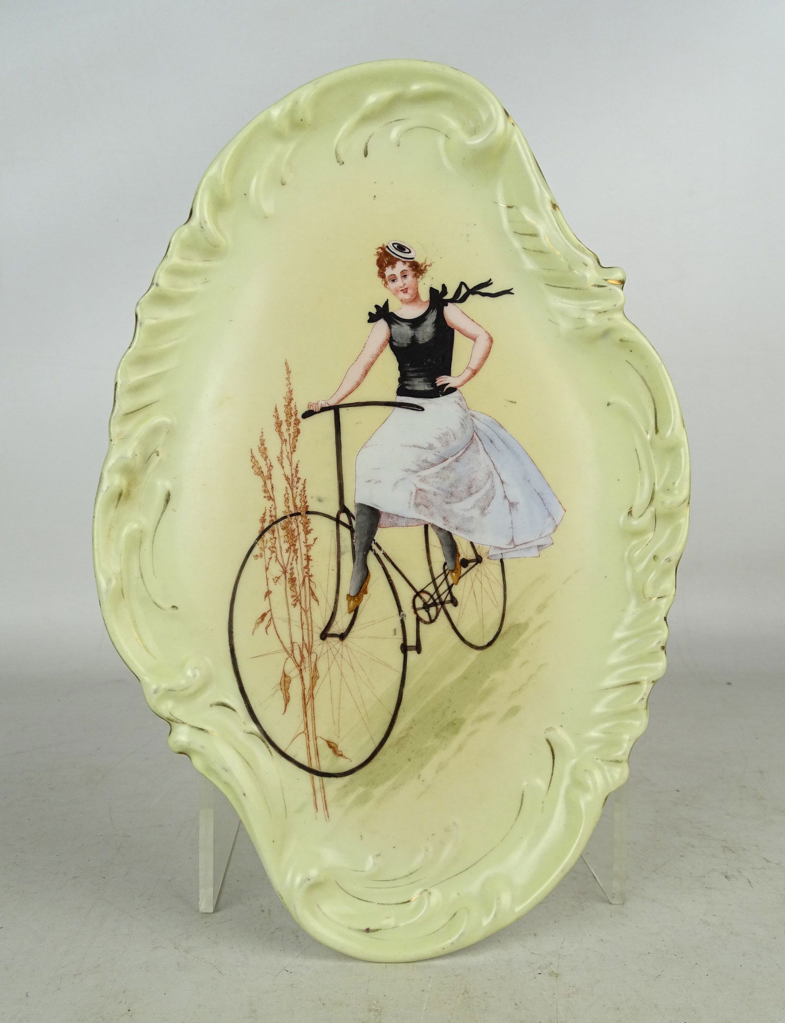 Hand-Painted Bicycle Dish: 19th. c. hand-painted dish, lady riding a hard tire safety bicycle. 10" x 6 1/2".