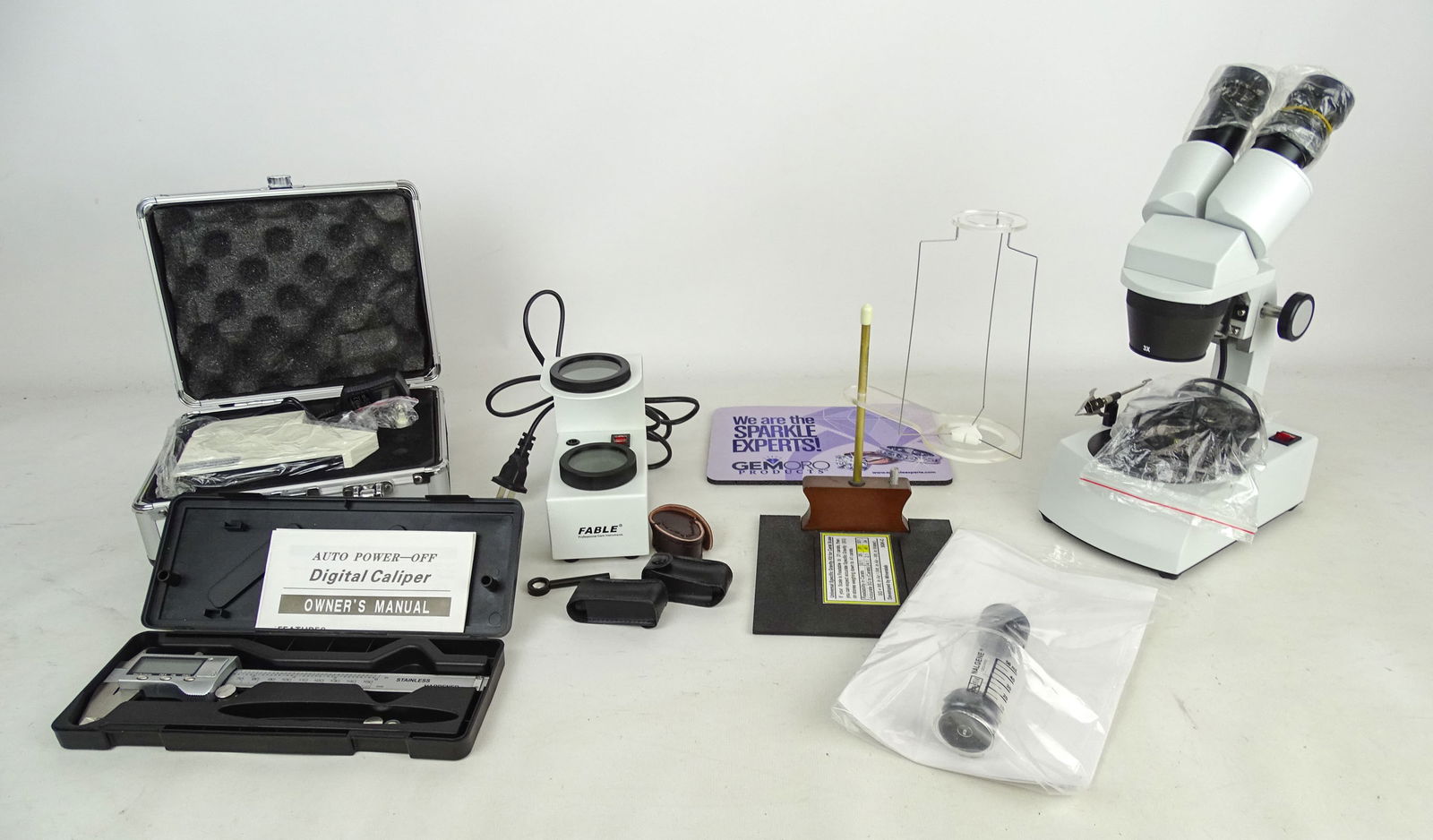 Gemology Equipment Lot: Gemology equipment lot including: digital caliper, Mineralab universal specific gravity kit, Fable polariscope, Chelsea filter, gem refractor, diffraction grating Spectroscope, Calcite dichroscope,
