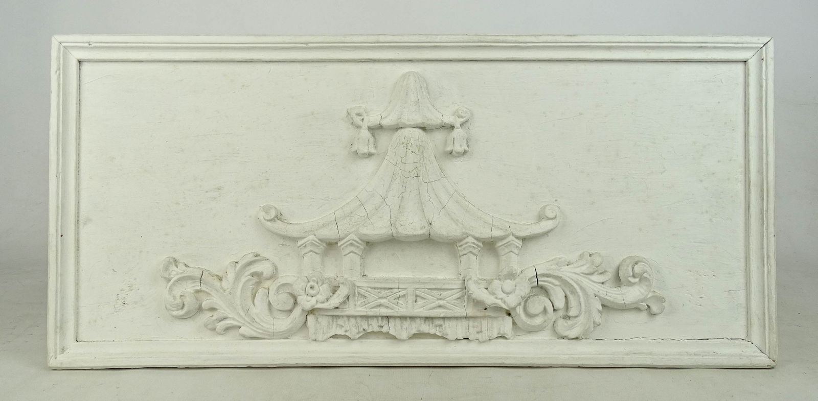 Carved Wooden Panel: Carved wooden panel in white paint. 10 1/2" x 22 1/2".