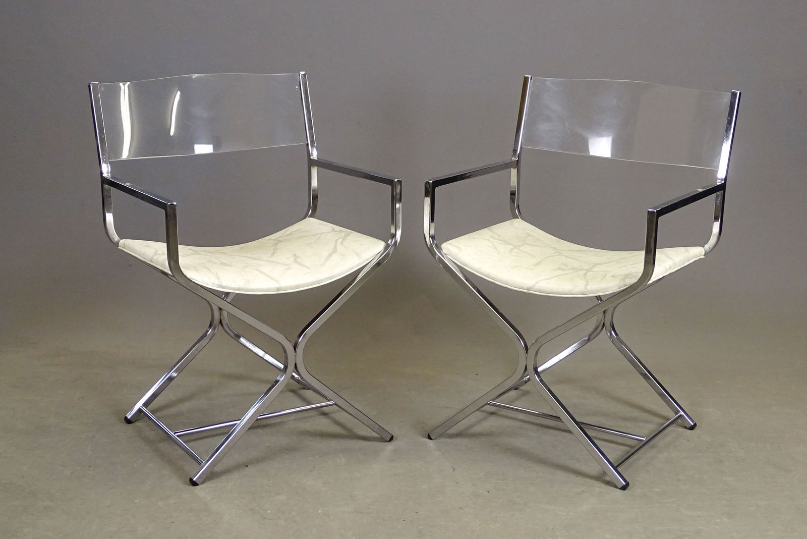 Pair MCM Lucite and Chrome Chairs: Pair of MCM Lucite and chrome chairs. 22" x 17" x 33".