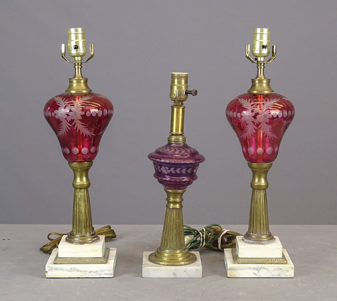 19th c. Oil Lamps: 19th c. colored glass whale oil lamps. Cut to clear, electrified, one pair (19" Ht.), and single (15 1/2" Ht.).