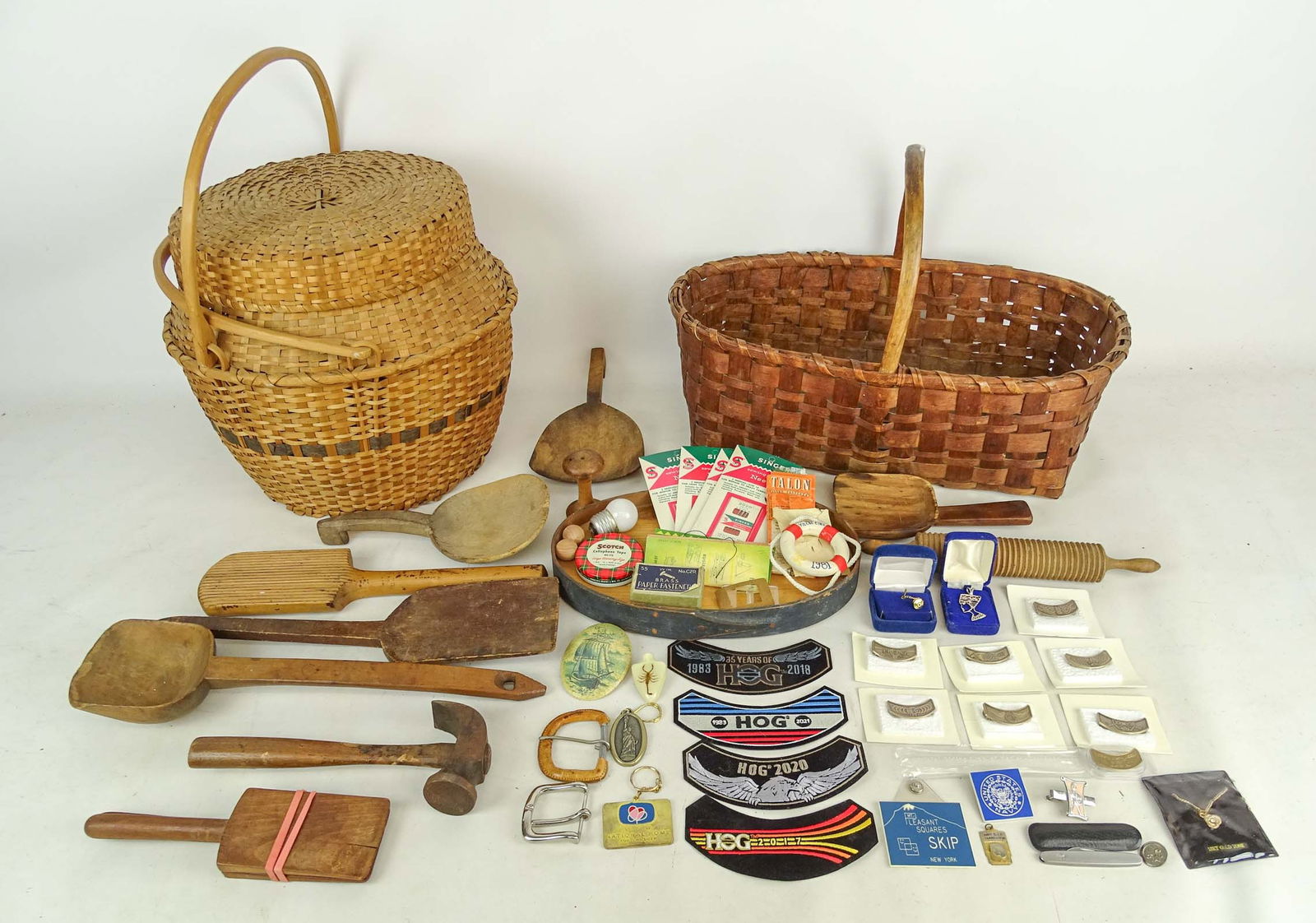 Woodenware Lot: Lot of (10) American woodenware utensils in a basket together with another basket with double handles and lidded (American Indian origin, early 20th Century).
