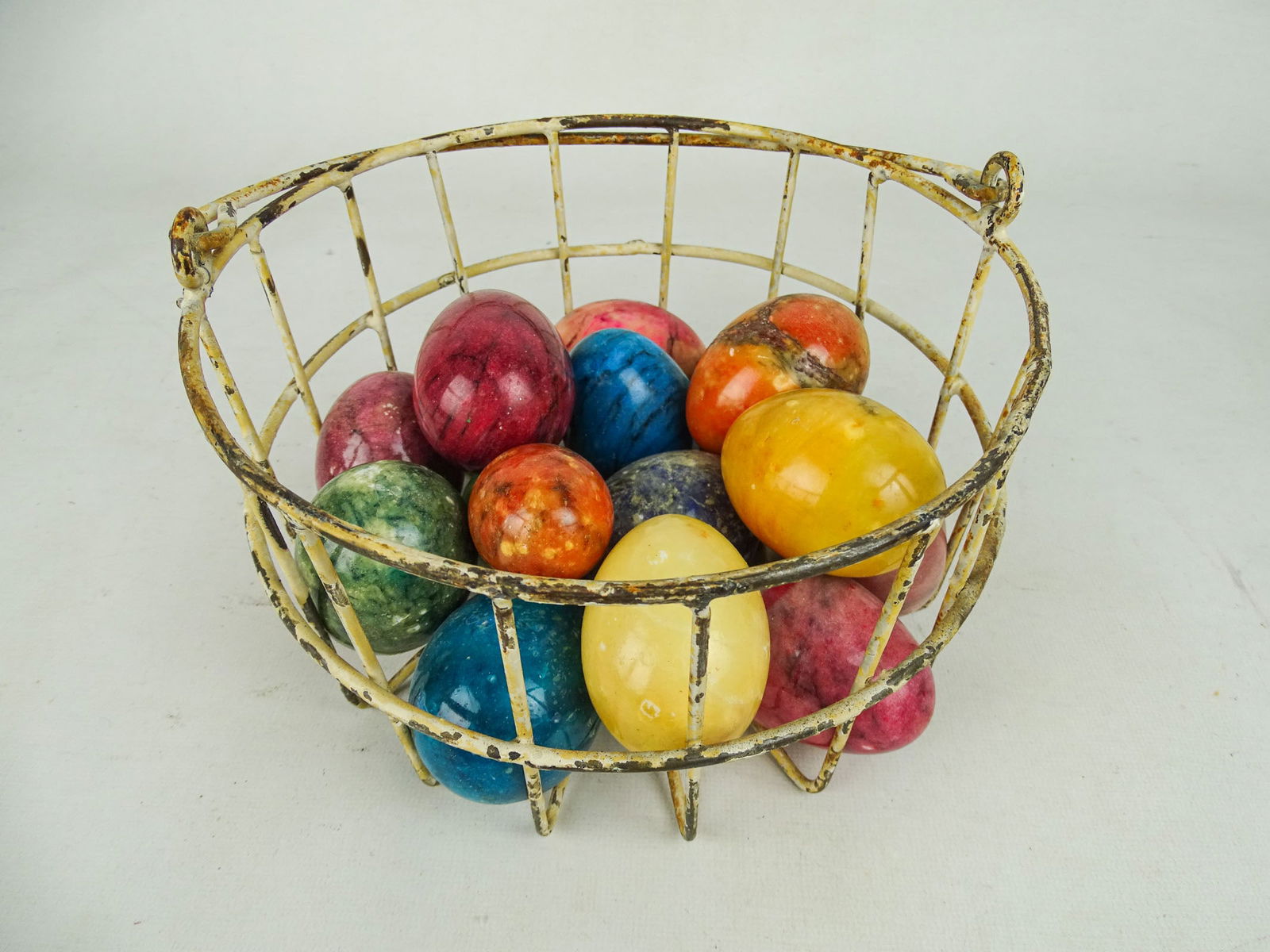 Egg Carrier with Stone Eggs: Vintage handled egg carrier with assorted stone eggs. Carrier 8" D., 4 1/2" Ht.. (eggs 2 1/2" L.).