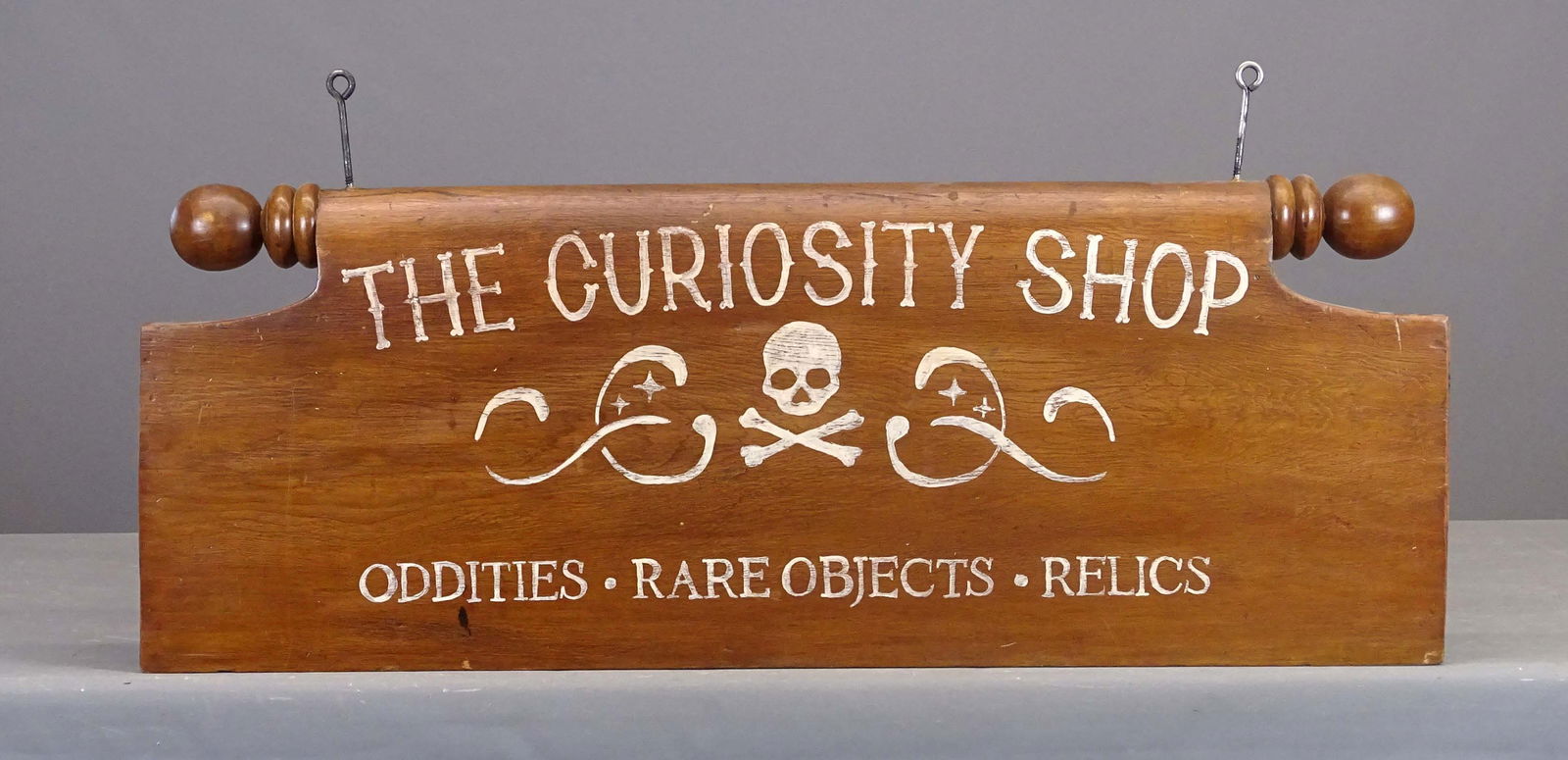 Curiosity Shop Trade Sign: "CURIOSITY SHOP…" wooden trade sign. Repurposed from bed part. 43" x 15".