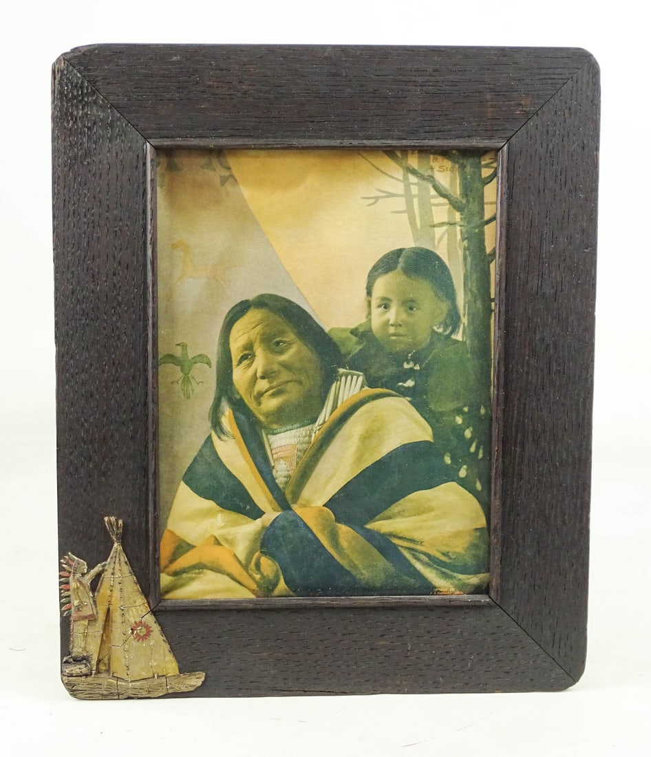 American Indian Print: Arts and Crafts period American Indian print with teepee decorated frame. 11 1/4" x 9 1/2". Label verso "EAGLE FEATHER AND PAPOOSE SIOUX COPYRIGHT 1901 F.A. RINEHART".