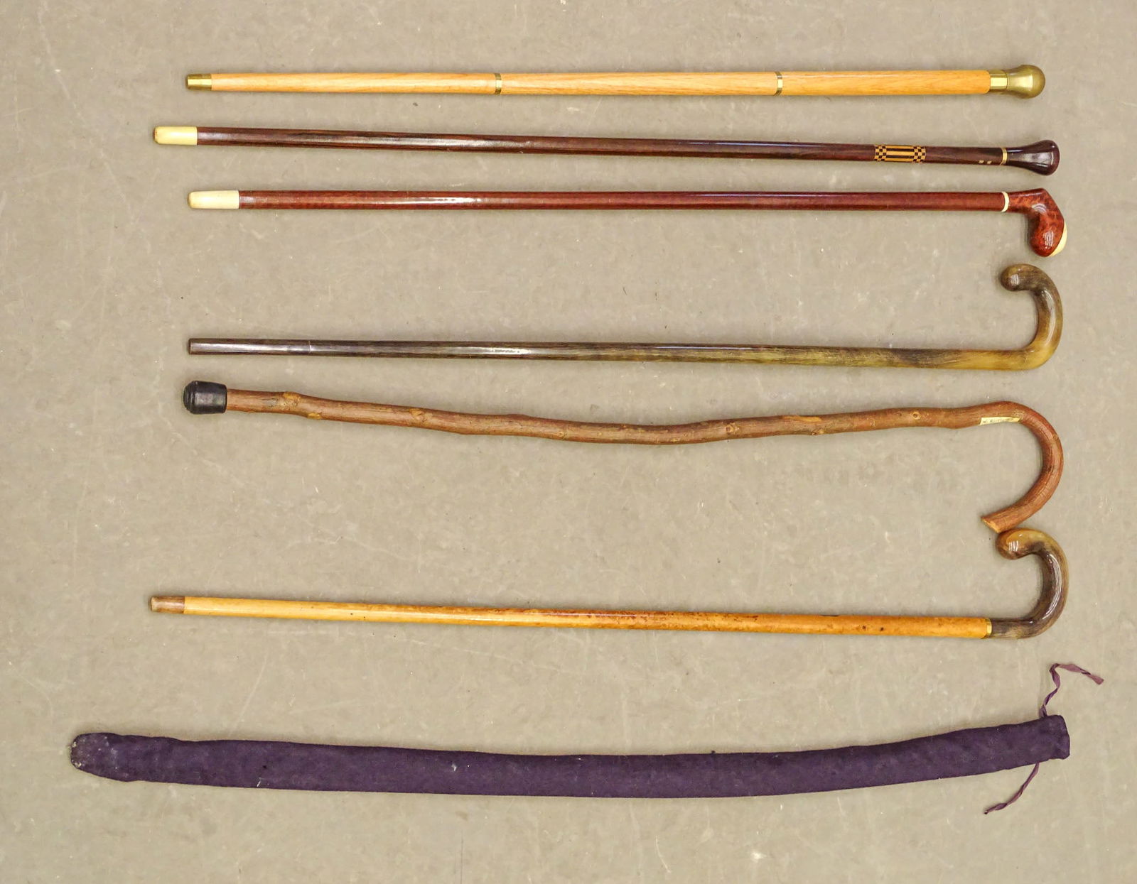 Walking Sticks: Collection of (6) assorted walking sticks. Includes brass top, inlaid, wooden etc.. Longest 36" L.. One band marked 14 Karat