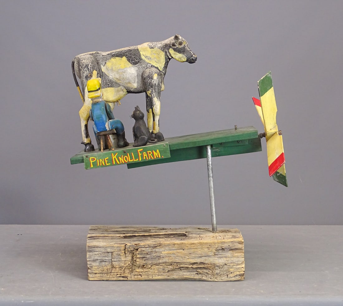 Folk Art Whirligig: Folk art carved wooden whirligig. Farmer milking cow. Mounted. Marked "PINE KNOLL FARM". 24" x 12" x 27 1/2".