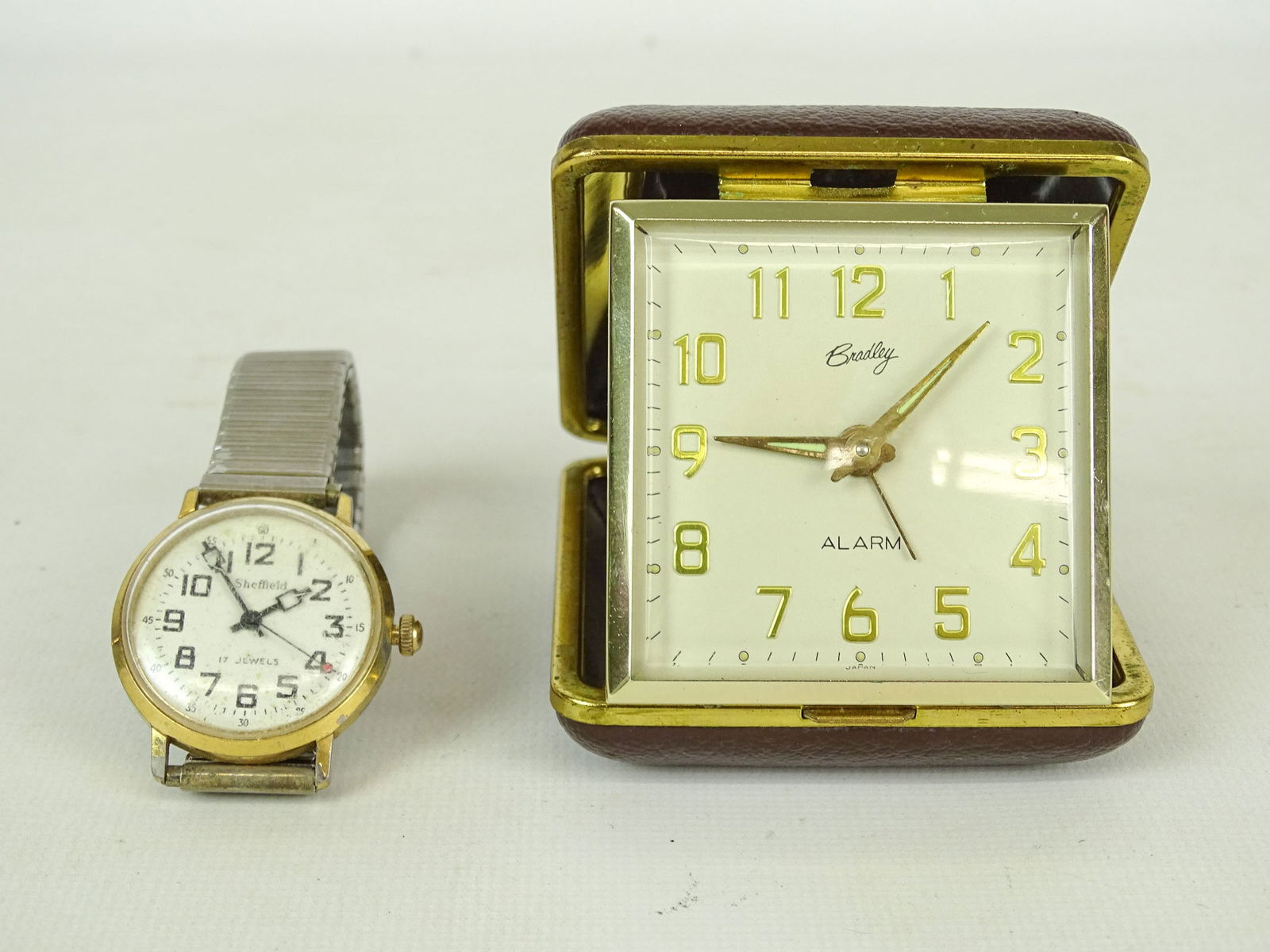 Watch and Alarm Clock Lot: Lot including: Bradley alarm clock (3" x 3"), and Sheffield wrist watch.