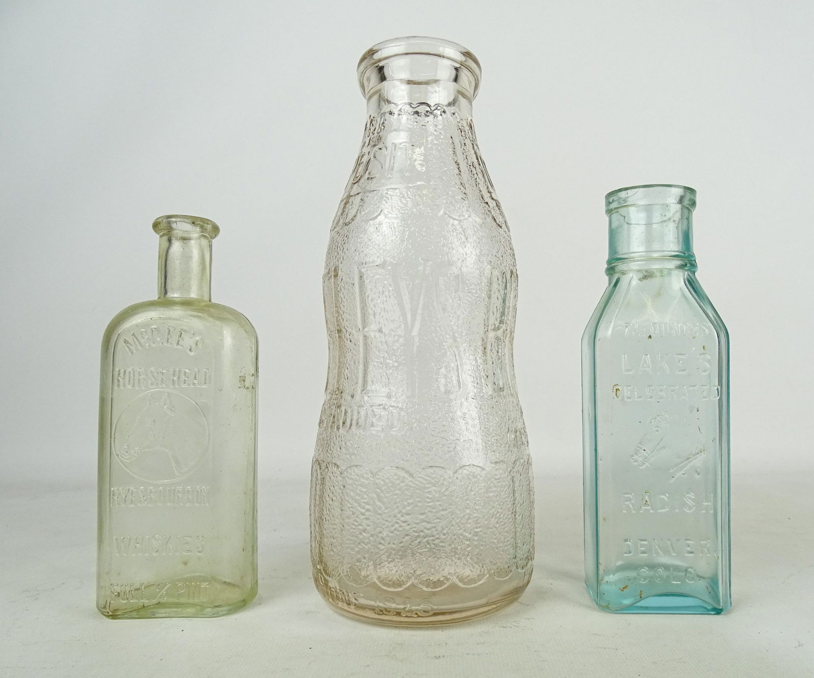 Bottle Lot: Lot (3) bottles including: "McGees Horsehead" (7" Ht.), "LAKE'S CELEBRATED" (7" Ht.), "BRELEYS" (10" Ht.).