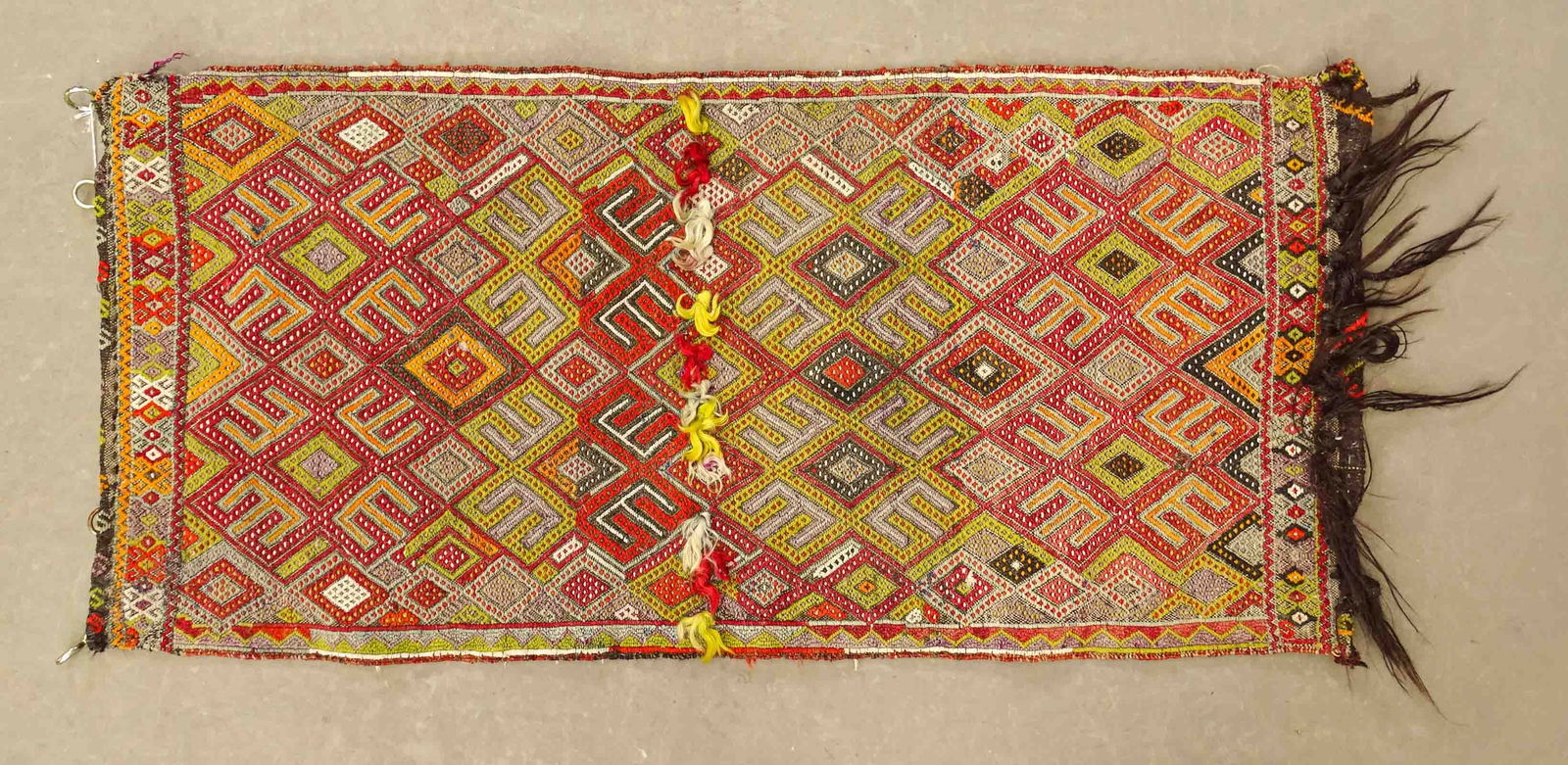 Oriental Rug: Oriental rug. 46" x 21 1/2". Has hangers for wall use.