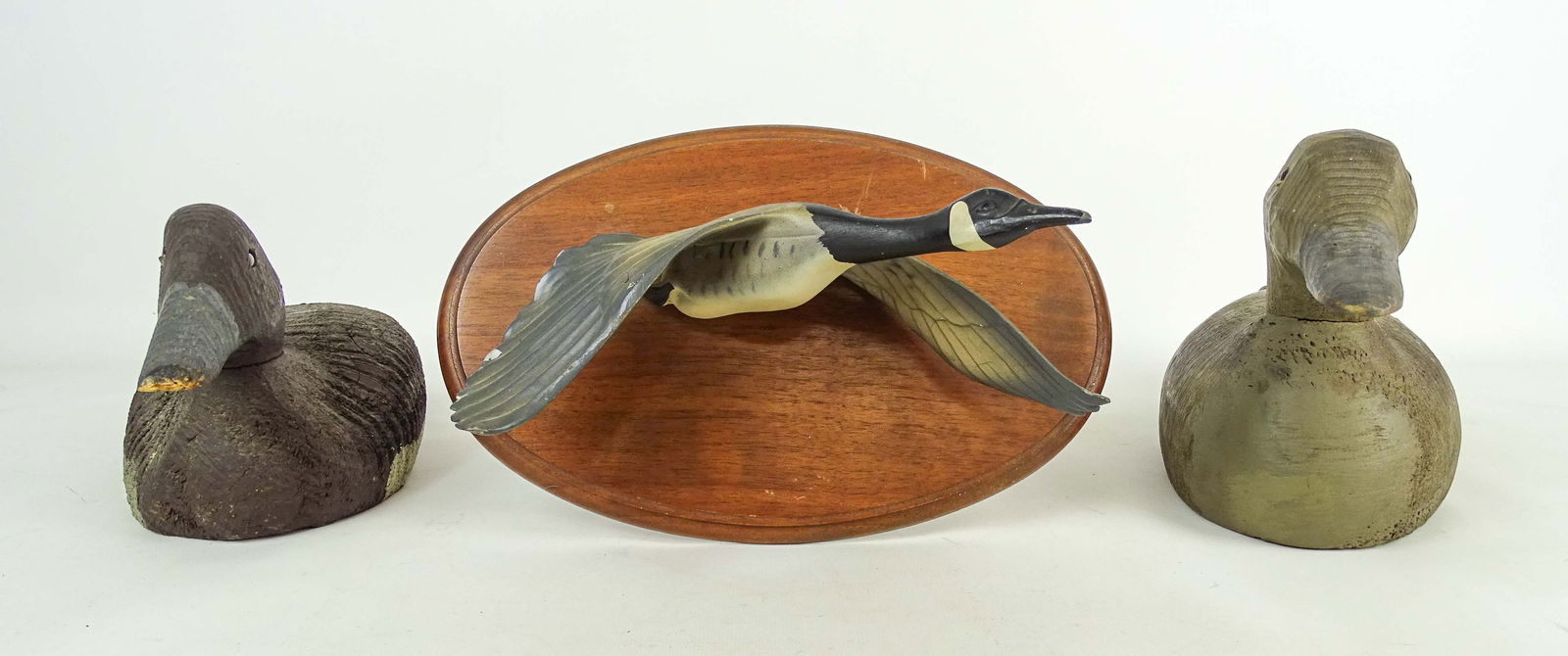 Decoy Lot: Lot including: Carved wooden decoy (16 1/2" L.), wooden decoy (13" L.), ceramic goose mounted to wood (11 1/2" x 4").