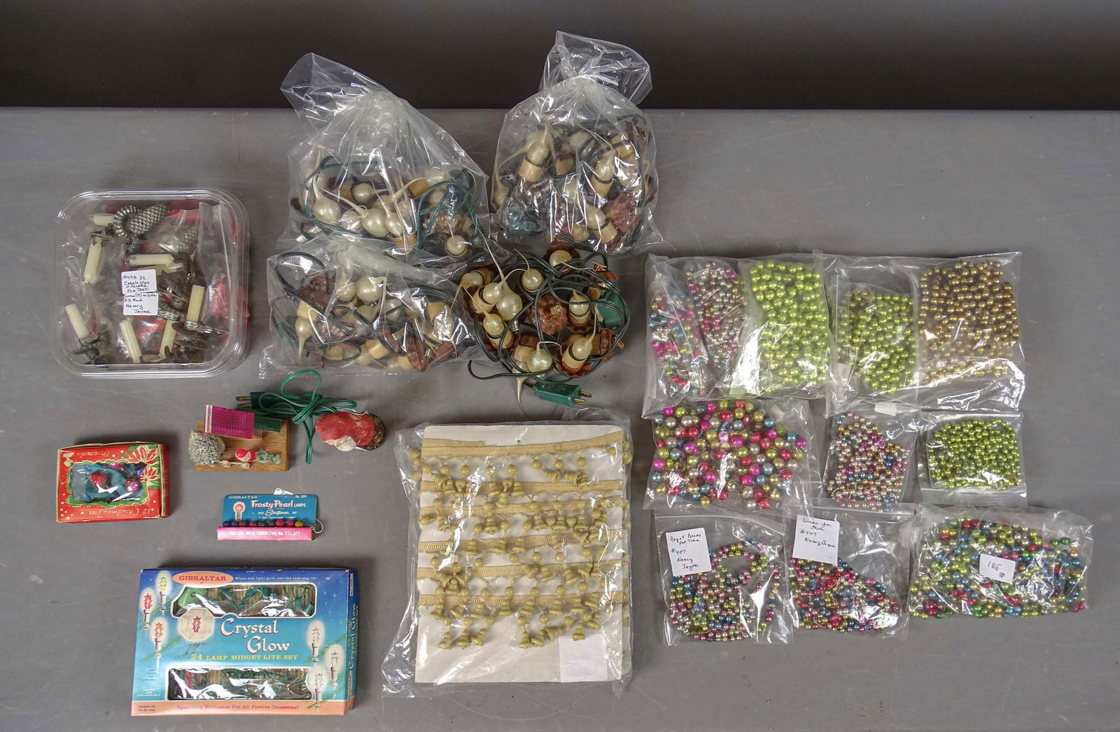 Christmas Lot: Christmas lot including: Wooden bell garlands, ornaments in box, 32 candle clips with candles, lights (working), beaded garland.