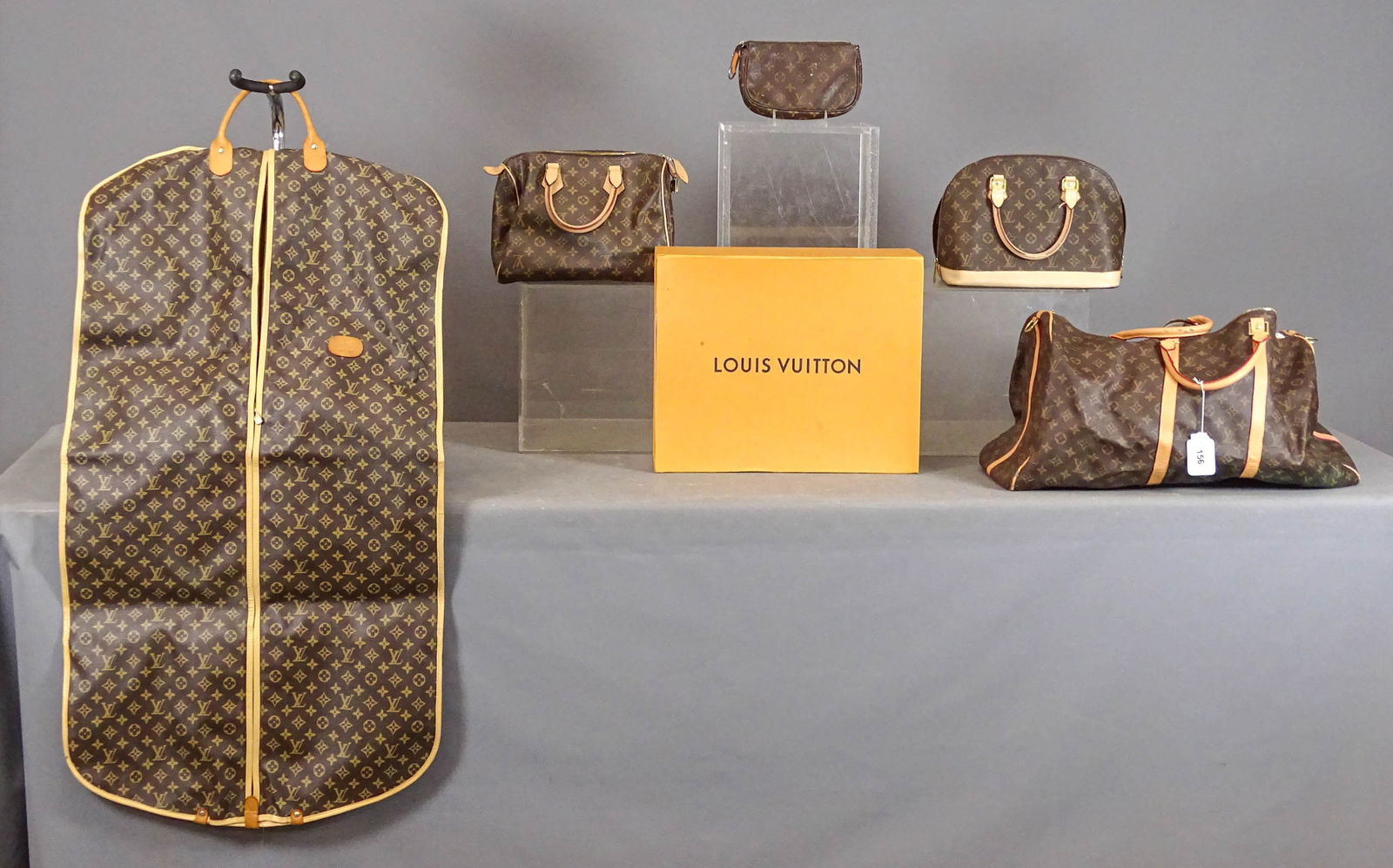 Louis Vuitton Style Lot: Louis Vuitton style lot including (5) various bags. Largest 23" x 14". Sold as "Style of", not guaranteed.