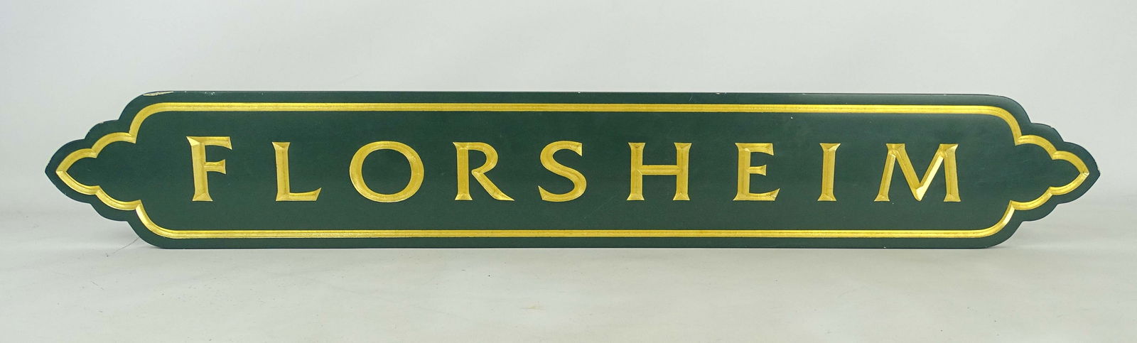 "FLORSHEIM" Sign: Wooden carved and painted sign "FLORSHEIM". Of recent manufacture. 36" x 5 1/2".
