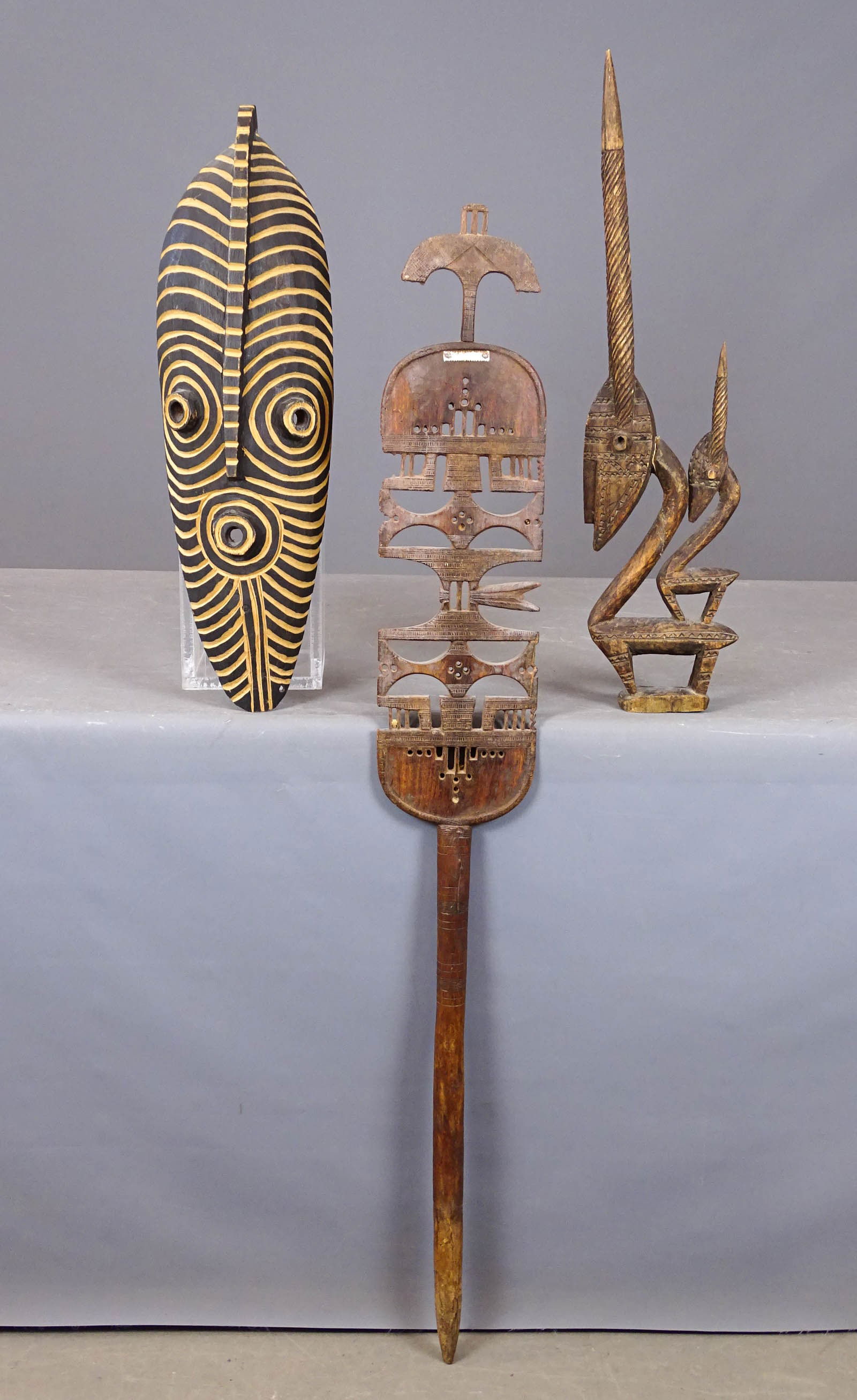 African Lot: Lot (3) African carved wooden pieces including: Seat back (48" L.), antelope (as is, 26" L.), mask (24" L.).