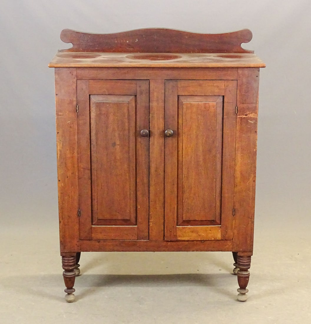19th c. Country Sheraton Cupboard: 19th c. Country Sheraton 2 door cupboard, having shaped splash back, raised panel doors and turned feet. 39" x 16 1/4", 5" splash back panel, 47 1/4" deck height.