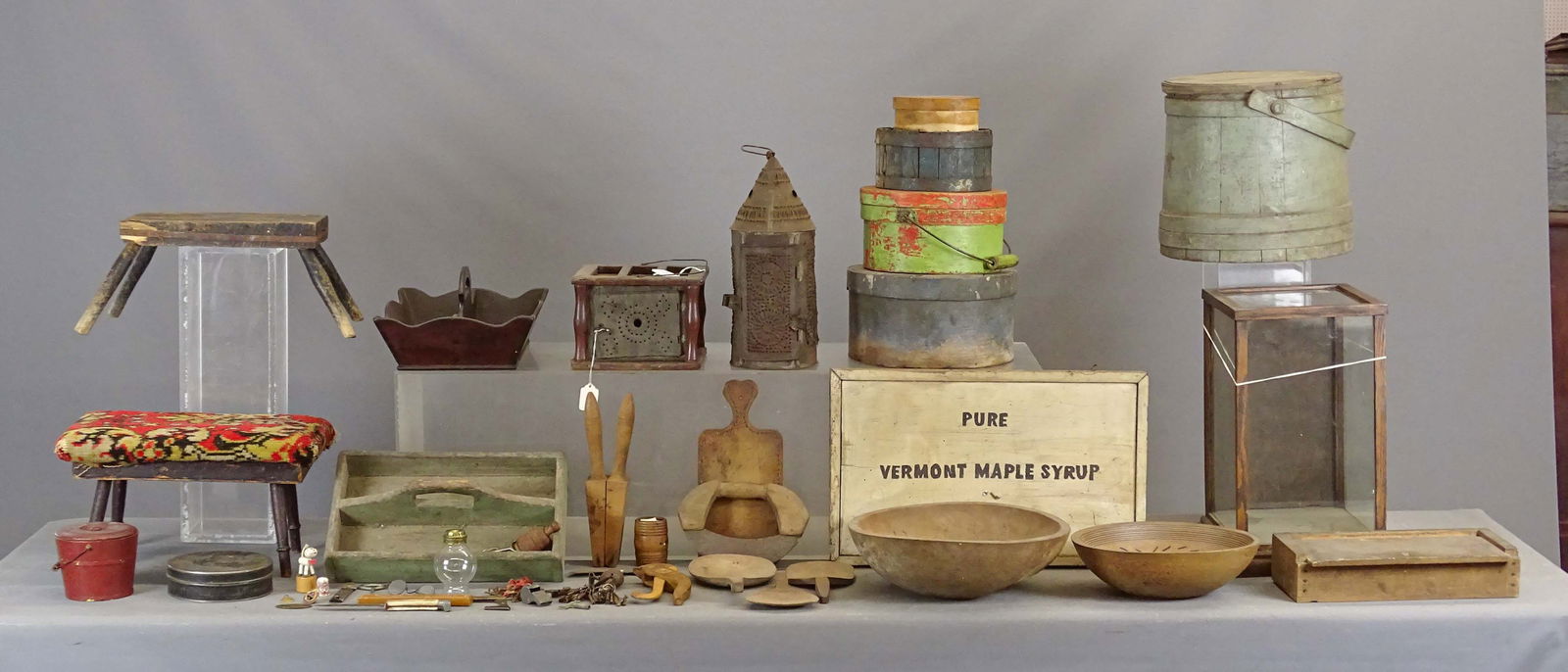 Primitives Collection: Primitives collection (24 pieces): small showcase (16" Ht), (2) cricket stools, (2) carriers, firkin, (4) pantry boxes, pierced tin lantern, foot warmer, covered swing handle pail "E. Murdock & Co",