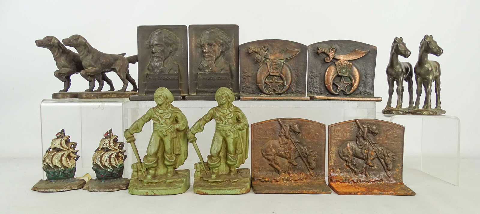 Bookends Collection: Bookends collection (7 pairs): "Galleons" 4" Ht, "Hunting Dogs" 4 3/4" Ht, "Pirates" 7" Ht, "Horses" 5 3/4" Ht, "Charles Dickens" 6" Ht, "Sword & Star" 4 1/2" Ht, "End of Trail" 4 1/2" Ht. Also Duck