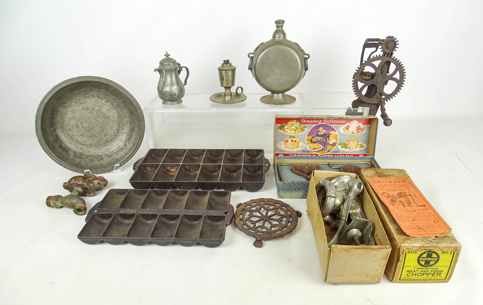 Misc Lot: Misc Lot: (2) Griswold French roll pans, (2) Griswold boxed "Patty Molds", boxed Griswold meat chopper, apple peeler "The Favorite", cast iron trivet, cast brass faucet with rabbit handle, and (4