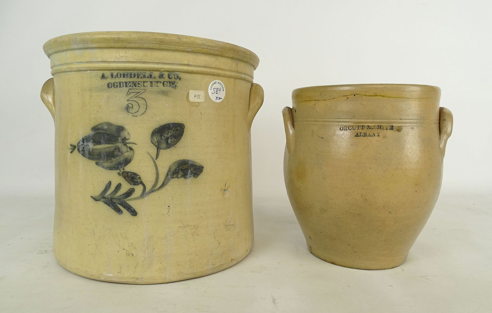 New York Stoneware Lot: New York Stoneware Lot: "A. Lobdell & Co. Ogdensburge" (3 gal. crock with floral decoration, 10 3/4" Ht), "Orcutt & Smith Albany" (crock, 9" Ht).