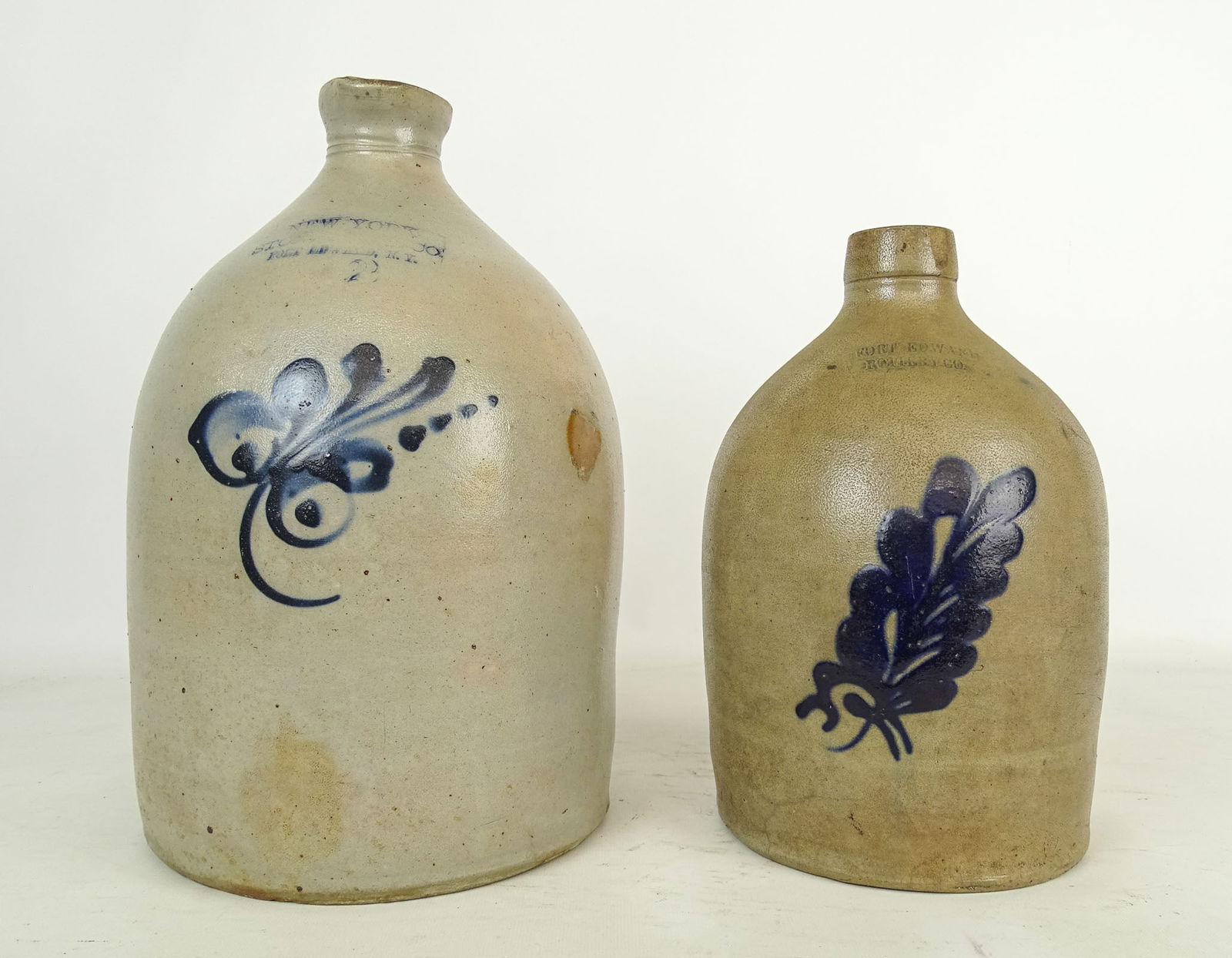 Fort Edward Stoneware Lot: Fort Edward Stoneware Lot: "Fort Edward Pottery Co" (11 1/2" jug with leaf decoration), "New York Stoneware Co Fort Edward NY" (2 gal. jug with leaf decoration, 14" Ht).