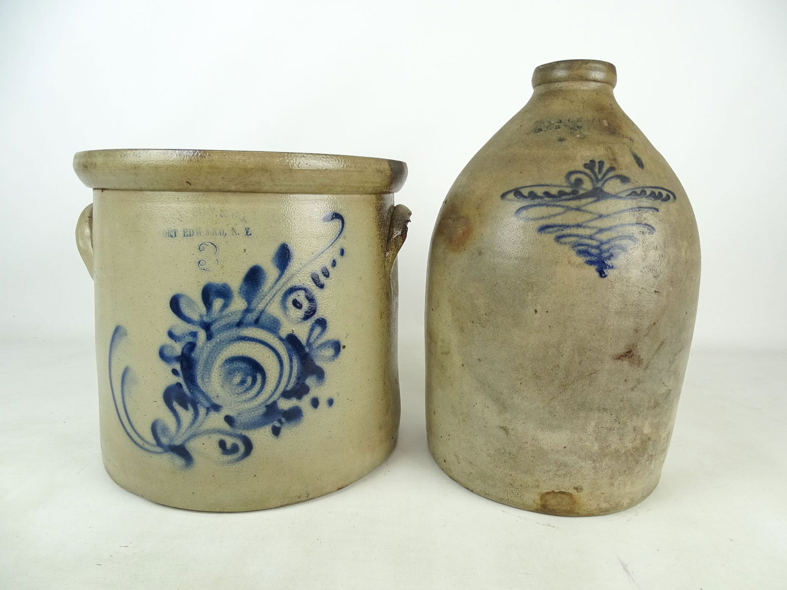Stoneware Lot: Stoneware Lot: "W.A. Lewis Galesville NY" (2 gal jug with swirl decoration, 13 1/2" Ht), "Haxstun Co Fort Edward NY" (3 gal crock with floral decoration, 10 1/4").