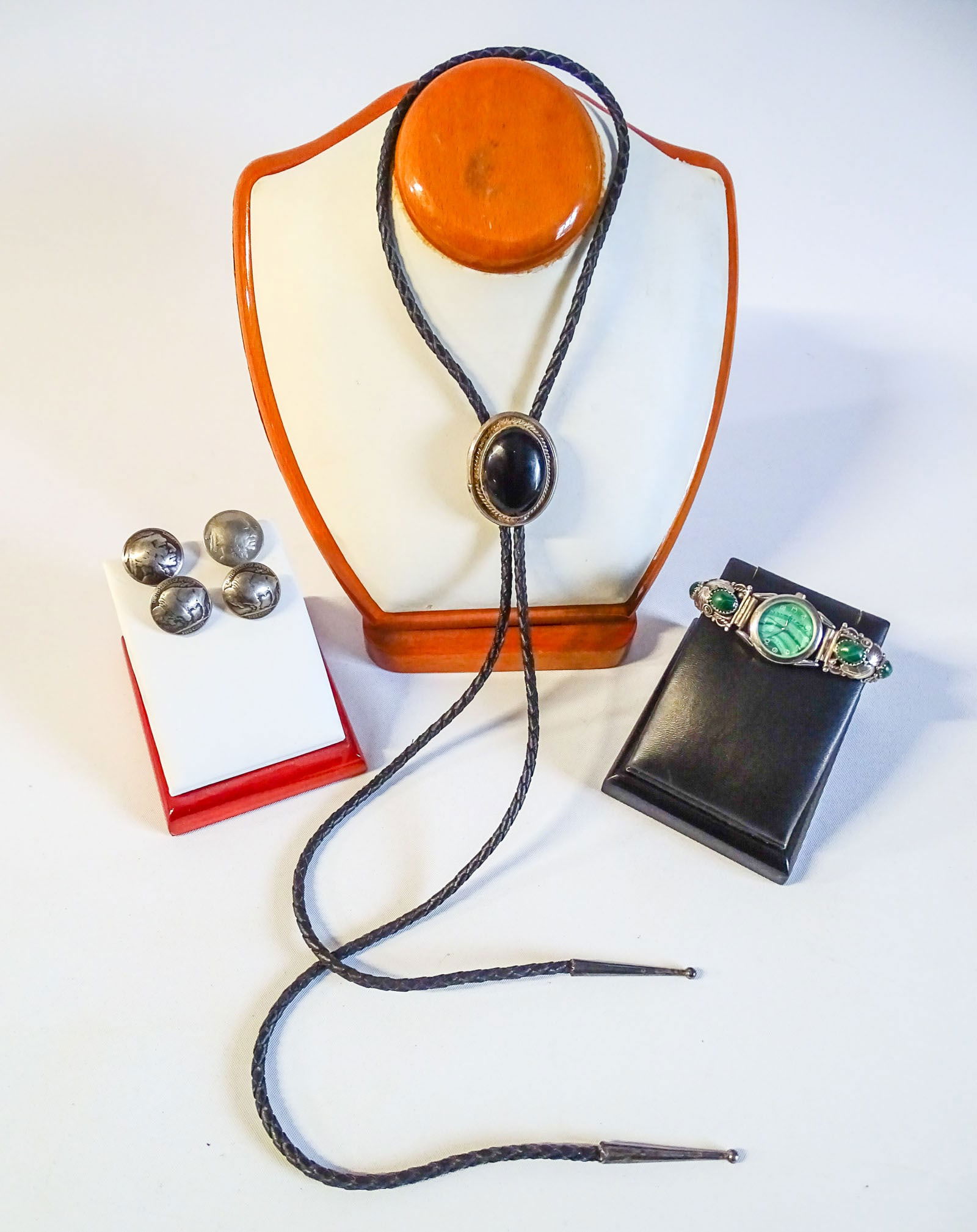 Navajo Silver Watch, Bolo Tie, & Buttons: Navajo silver watch stretch band. Carved silver leaf design with Malachite stones. Signed "AS"; Leather Bolo Tie, silver and black onyx cabochon, 40" black leather tie with silver tips; x4 vintage