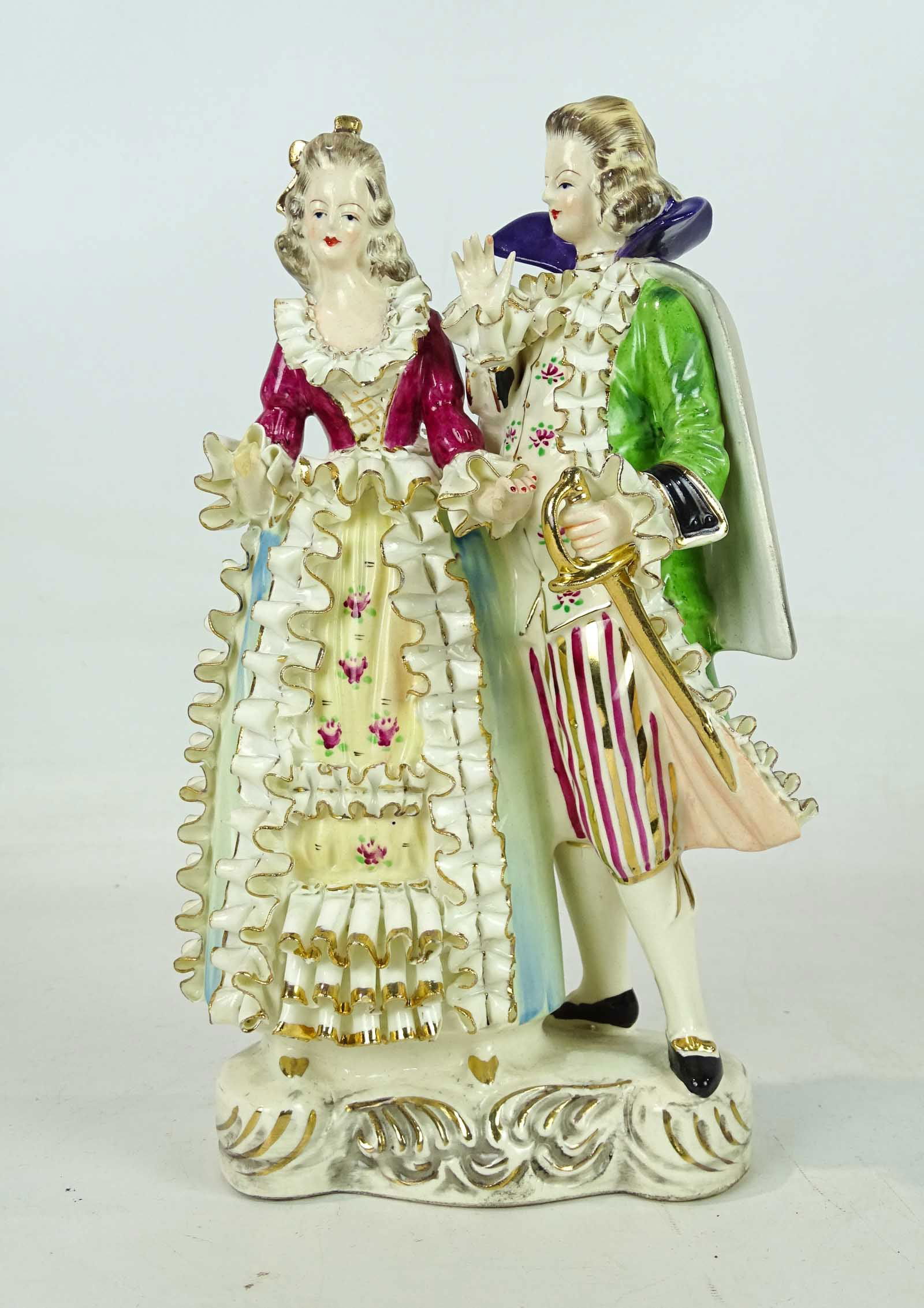 Aristocratic Couple Porcelain Figurine: Woman and man in elegant 18th century formal dress. Signed underside Bone China Lace. Ceramic, soft-paste porcelain, painted and gilt. 11 1/4" Ht..