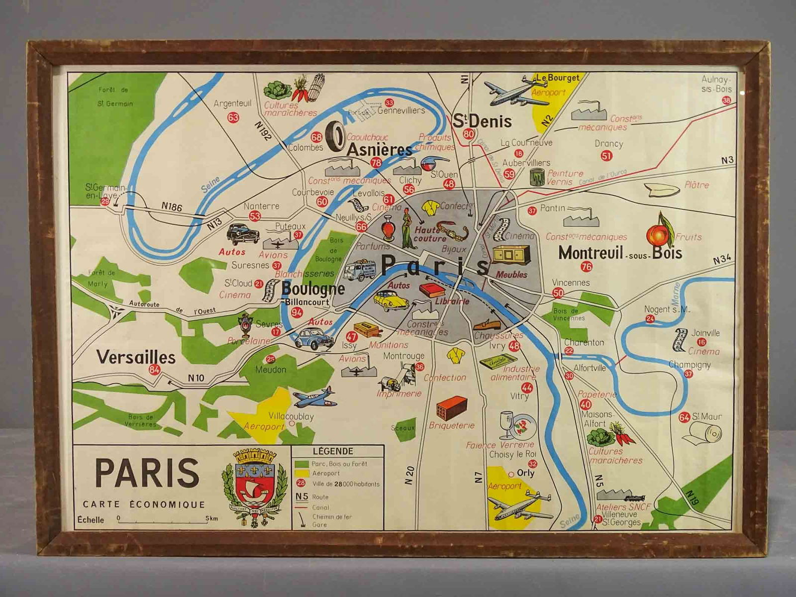 New York City composite view, Paris Pictorial Map: Paris Carte Economique. Pictorial map of Paris, with rivers, roads, parks. Images include planes, cars, haute couture and parfums. Reproduction.. Sight 19" x 28", overall 21 1/2" x 30 1/2".