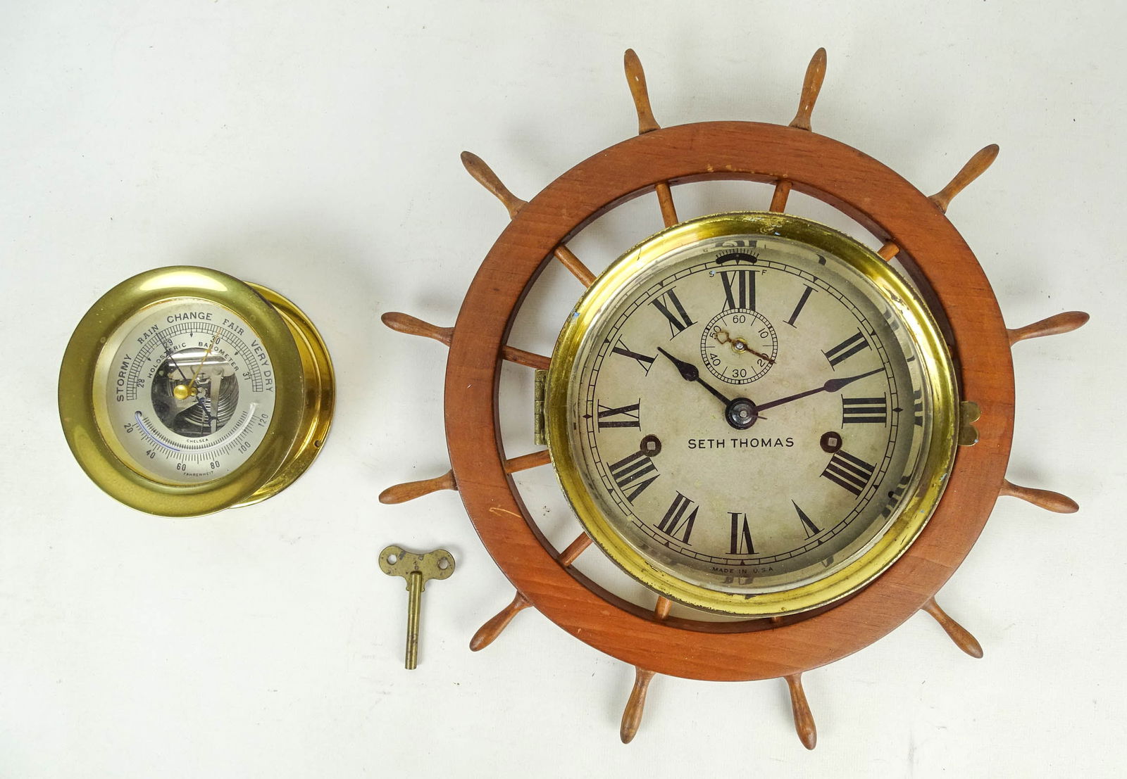 Seth Thomas Ships Wheel Clock: Vintage Seth Thomas Ship's Wheel clock. Brass and wood. 14" D., along with Chelsea brass Holosteric Barometer (5" D.).