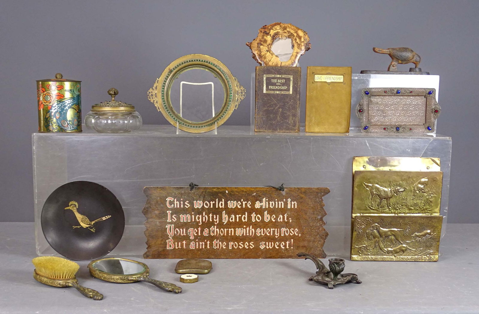 Misc. Lot: Lot including burl mirror (5" D.), brass embossed wall rack (9" x 10"), iron chamberstick (8" L.), bronze (4) piece jeweled dresser set, cigarette box, wooden Motto sign (7" x 17 1/2"), Ralph Waldo Em