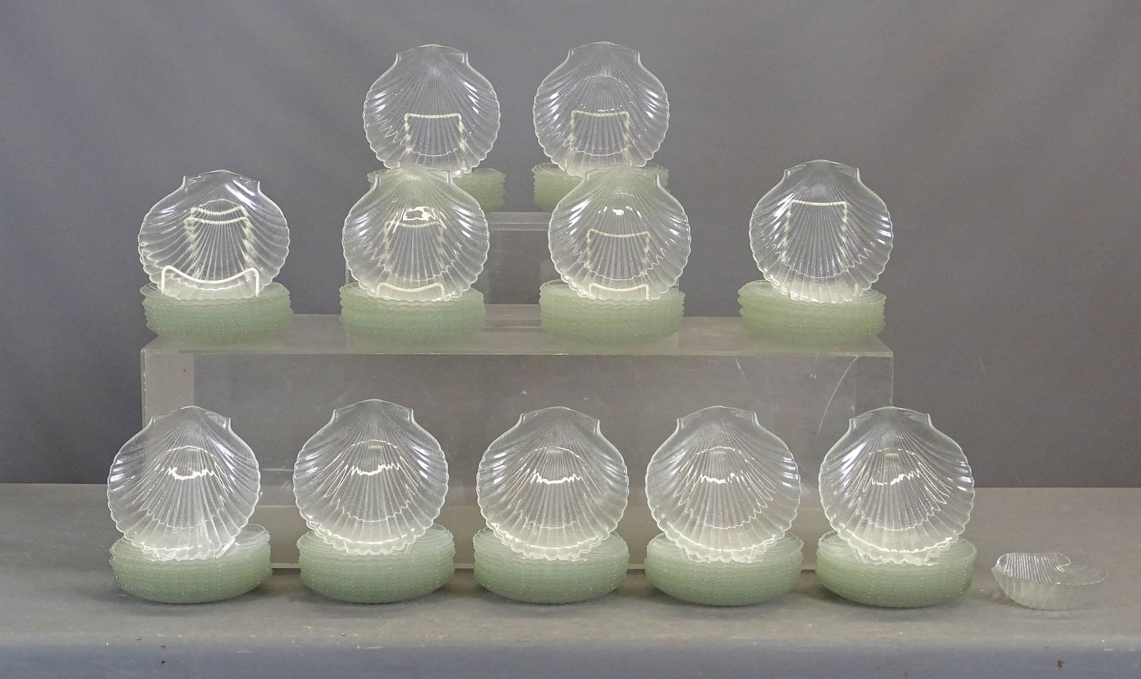 Set of Shell Serving Plates: Set of (108) 8" D. clear shell dishes. Some imperfections, mostly good shape. Along with a bowl.