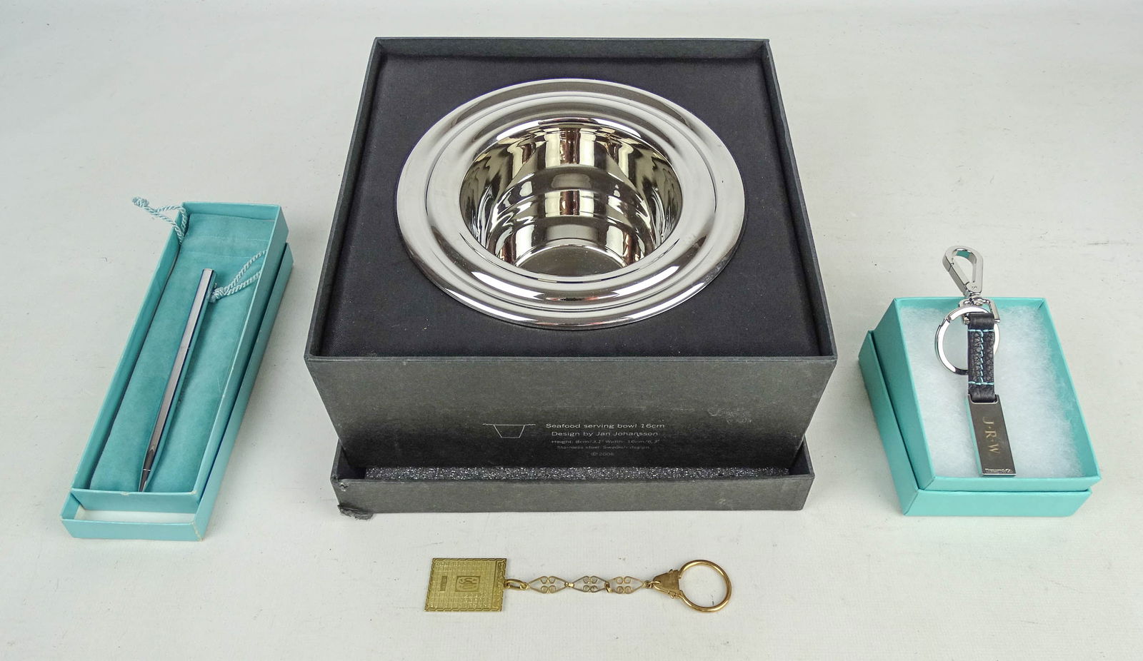 Orrefors and Tiffany Lot: Lot including boxed Orrefors bowl in original box (bowl 6 1/2" D., 4" Ht.), Tiffany boxed keychain, Tiffany boxed pen.