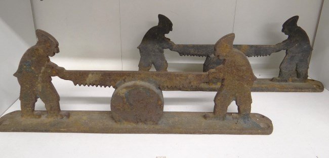 Bootscrapers: Lot two cast iron bootscrapers men sawing wood.