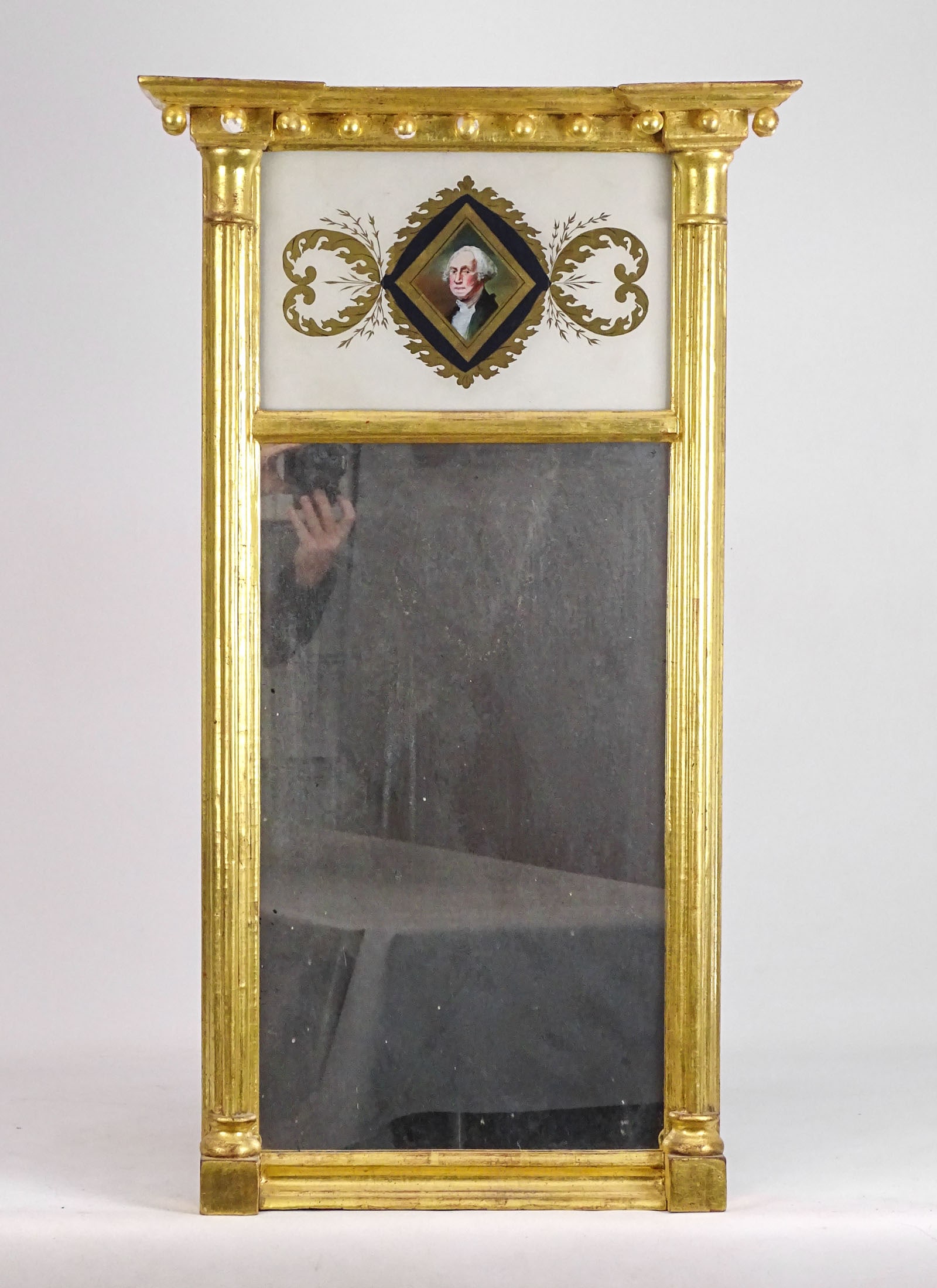19th c. Federal Mirror: 19th c. split panel gilded Federal mirror. Top eglomaise tablet with George Washington portrait. 21" x 37".