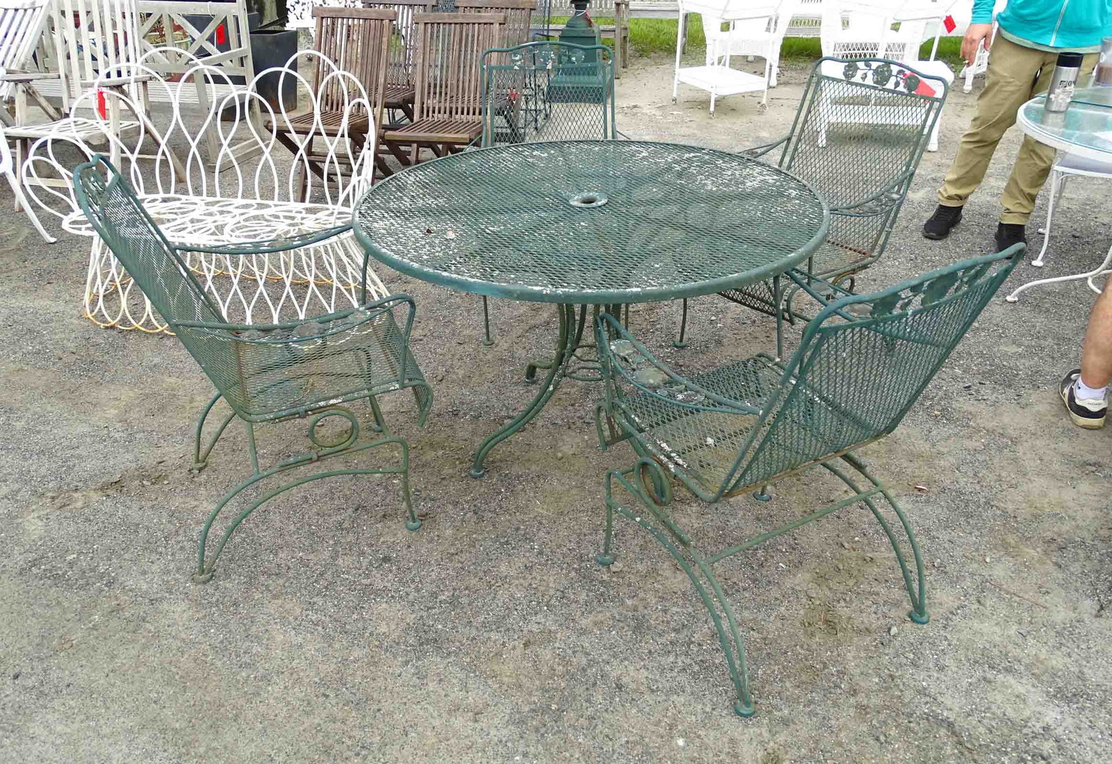 Wrought Iron Patio Set: Wrought iron patio set. Table 48" D., and (4) chairs.