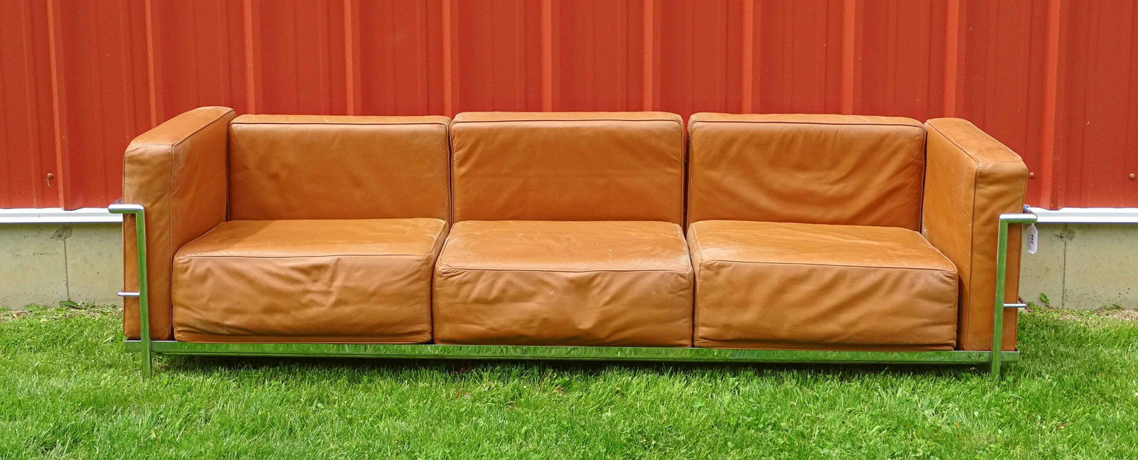 Le Corbusier Mid Century Sofa: Le Corbusier style LC2 three-seater sofa. Cognan leather with polished chrome frame. 90" x 27" x 26 1/2" Ht..