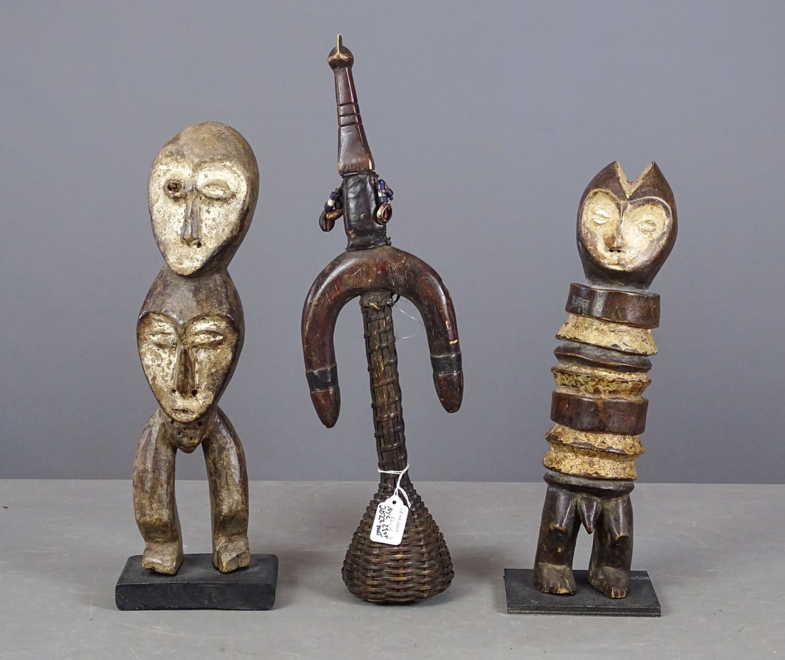 African Lot: Lot of African carvings including: (2) Lega Bwanni figure (16" Ht.), child's rattle. 19" L..