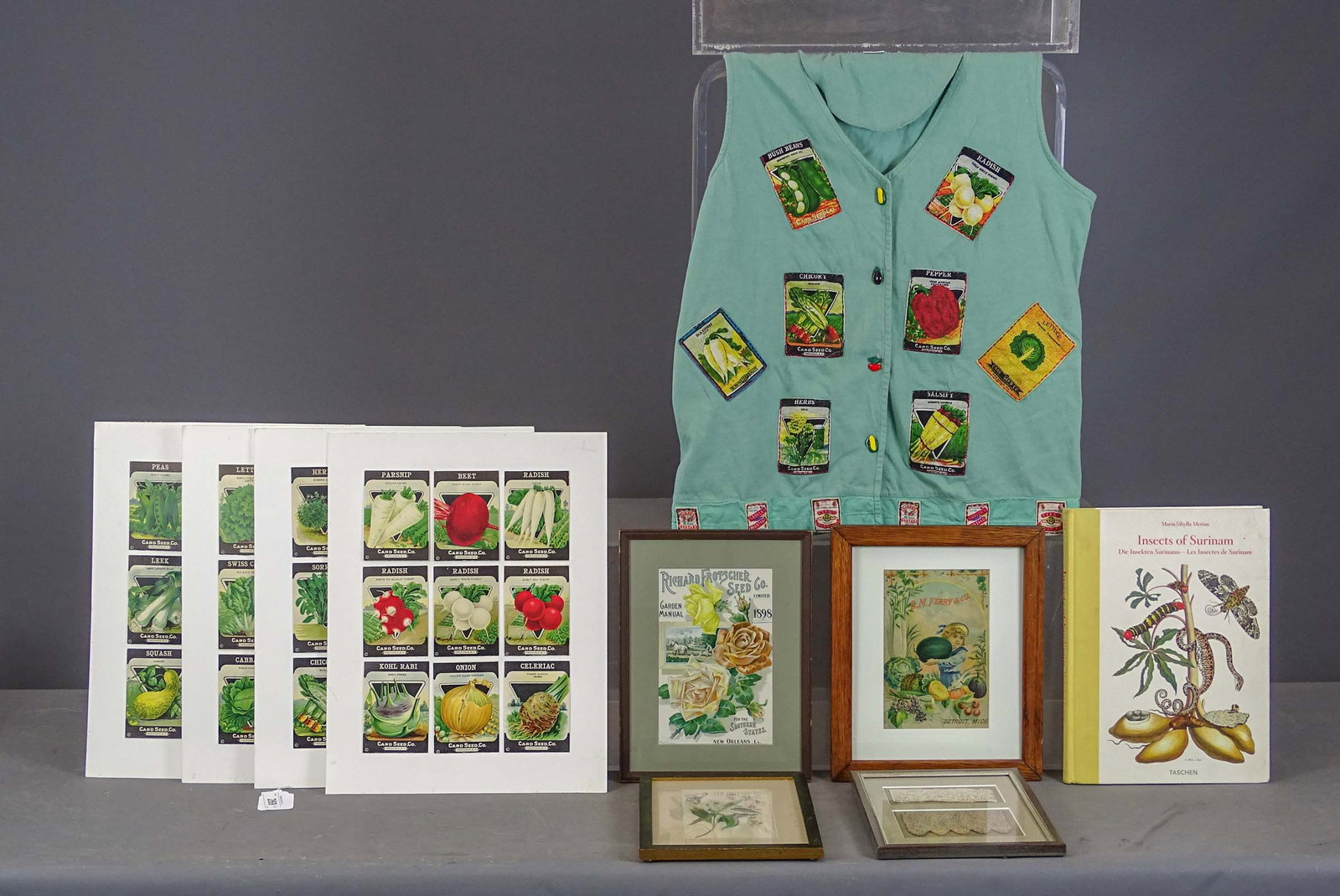 Seed Packets Lot: Lot including: Seed packet labels (overall on white board 18" x 14", and shirt with seed packet designs (size small), Book "Insects of Surinam" (14" x 10"), framed trade card "D.M. FERRY & CO."