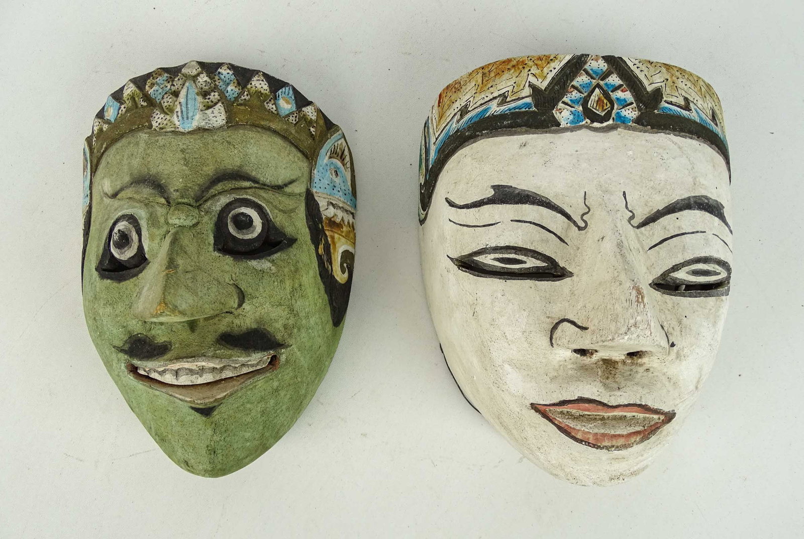 Indonesian Masks: Lot (2) wooden polychrome painted Indonesian masks. Largest 8" x 6" x 5" D..
