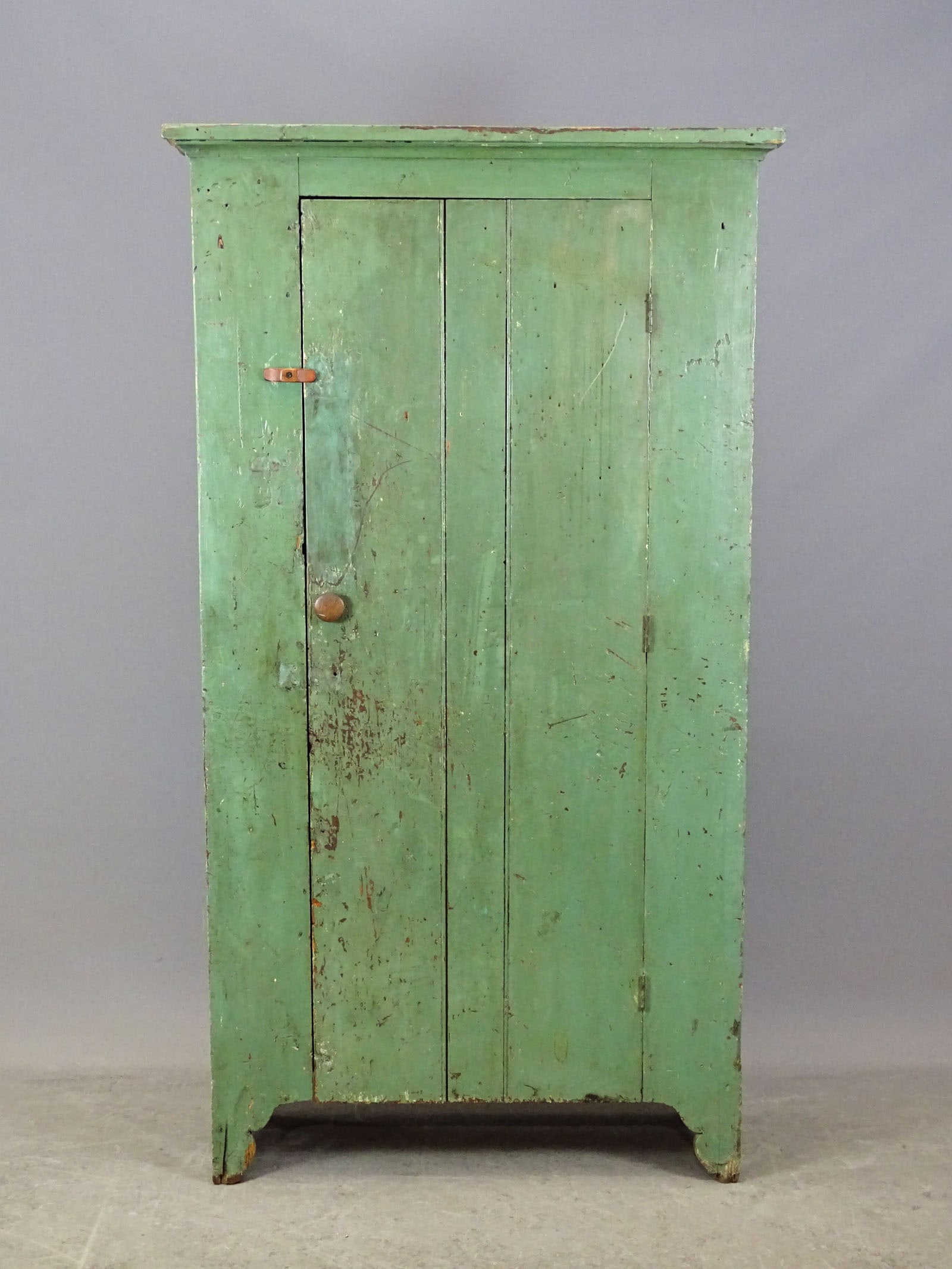 19th c. Wall Cupboard: 19th c. single door wall cupboard in old green paint. Bootjack base. 38" x 14" x 72" Ht..