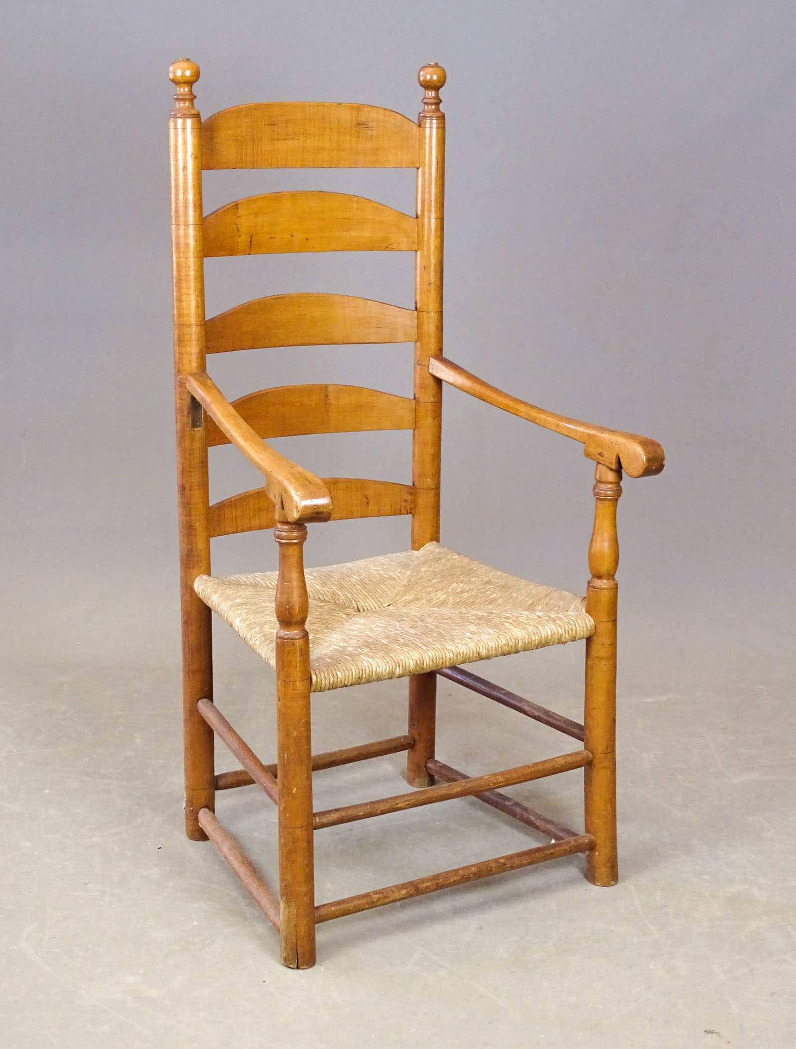 19th c. Armchair: Early 19th c. tiger maple maple ladderback armchair with rush seat. 15 1/2" seat Ht., 44 1/4" overall Ht..