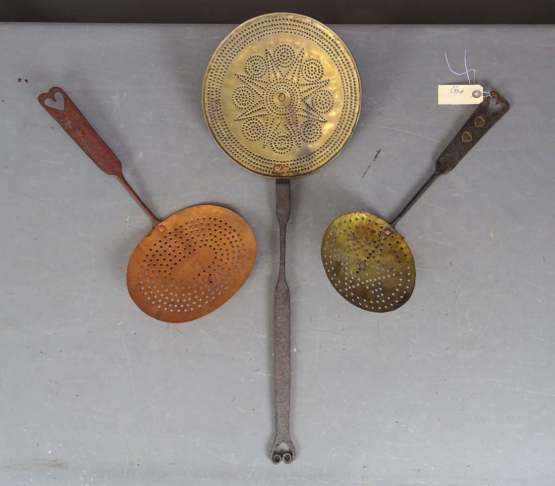Lot (3) Strainers: Lot (3) iron, copper and brass strainers. Two with heart motifs. Longest 26" L..