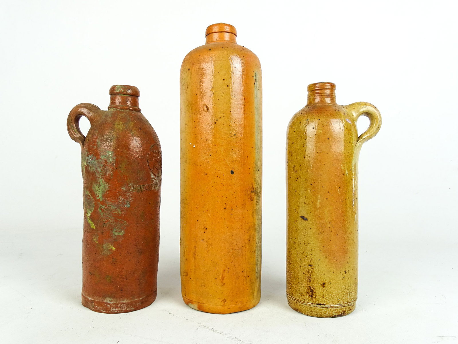 Three Early Salt Glaze Beer Bottles: Three early salt glaze European beer bottles. Tallest 12" Ht..