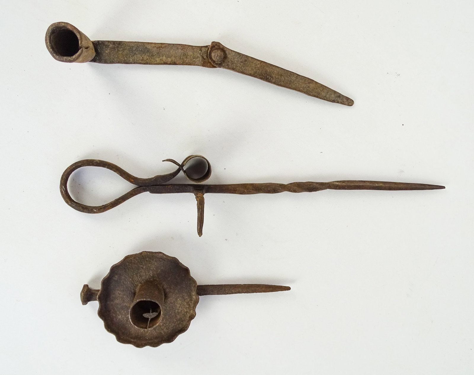 Iron Sticking Tommy Candleholders: Lot (3) iron Sticking Tommy candle holders. Longest 14 1/2" L..